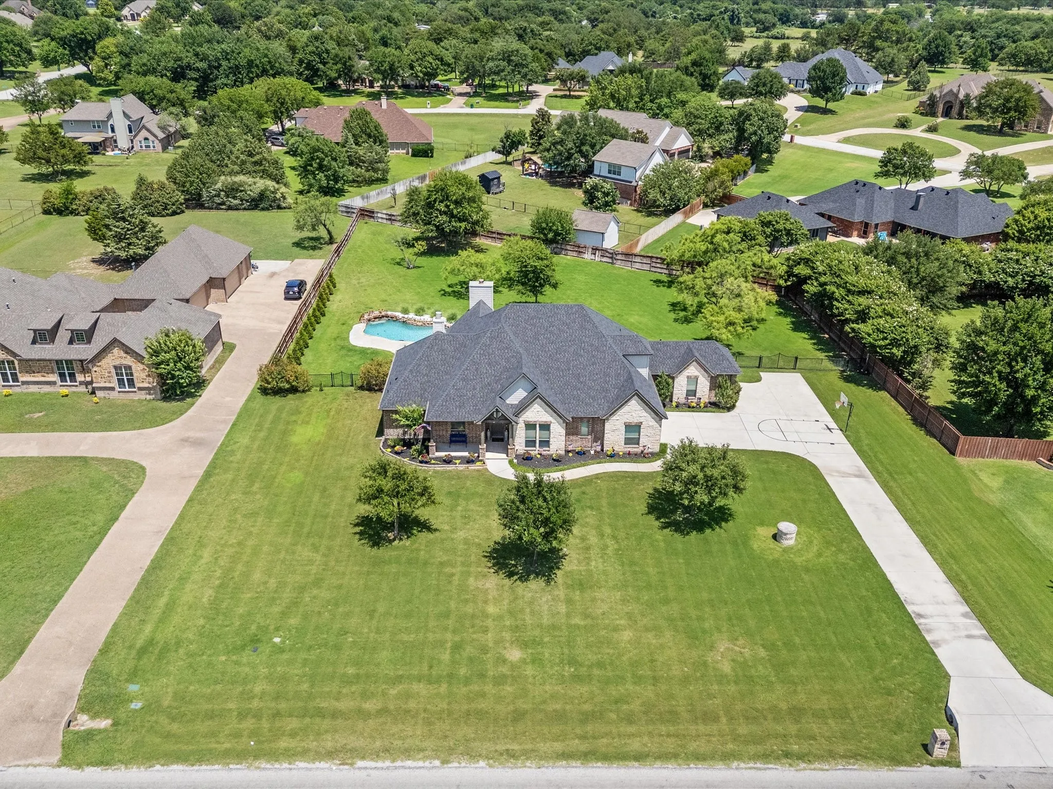 Beautifully updated custom home situated on a one-acre lot in Aurora Vista with mature landscaping, stone accents, and exceptional curb appeal.