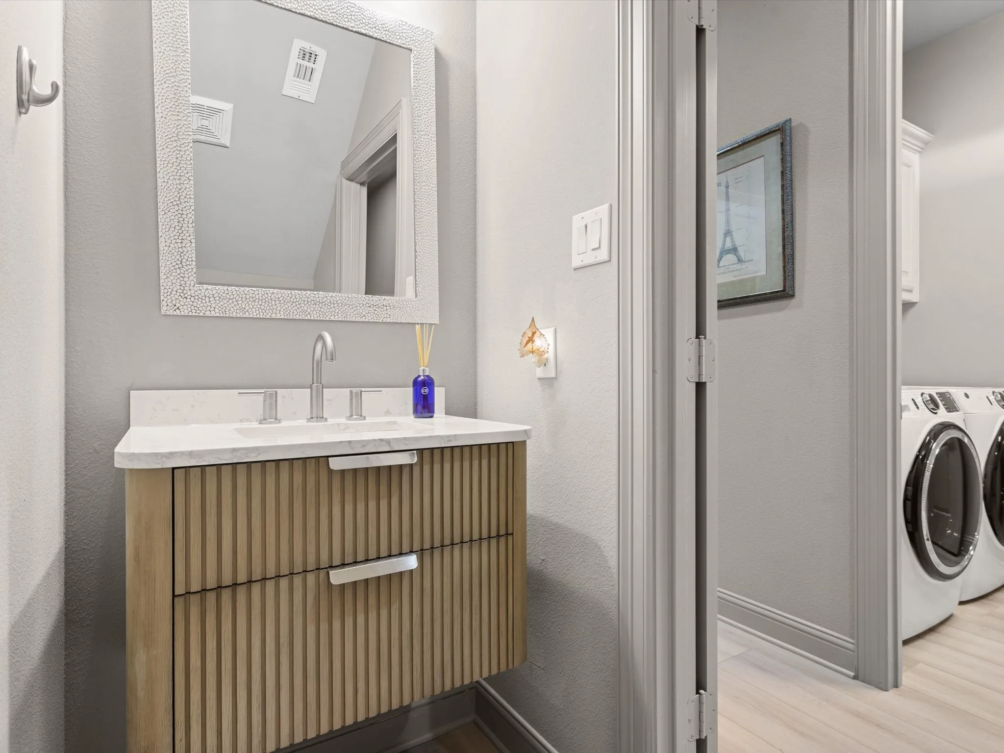 Completely remodeled half bath featuring updated fixtures and modern finishes.