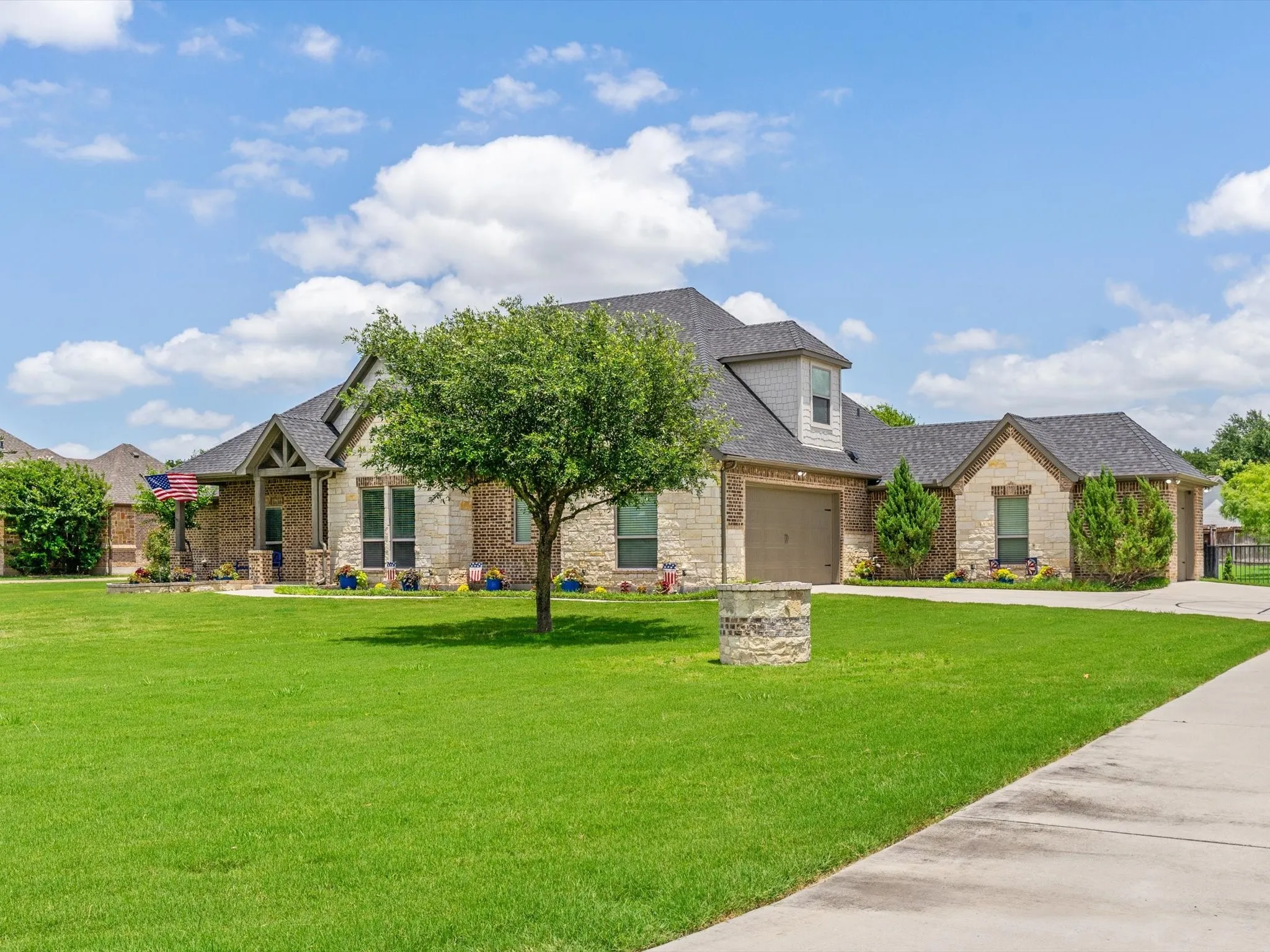 Beautifully updated custom home situated on a one-acre lot in Aurora Vista with mature landscaping, stone accents, and exceptional curb appeal.