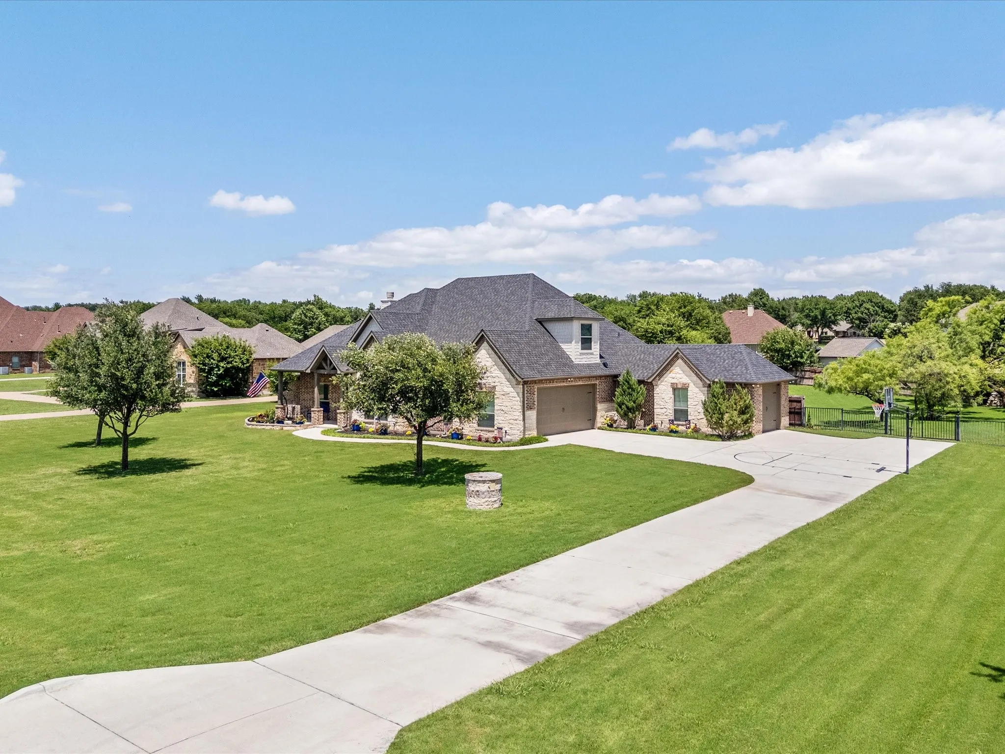 Beautifully updated custom home situated on a one-acre lot in Aurora Vista with mature landscaping, stone accents, and exceptional curb appeal.