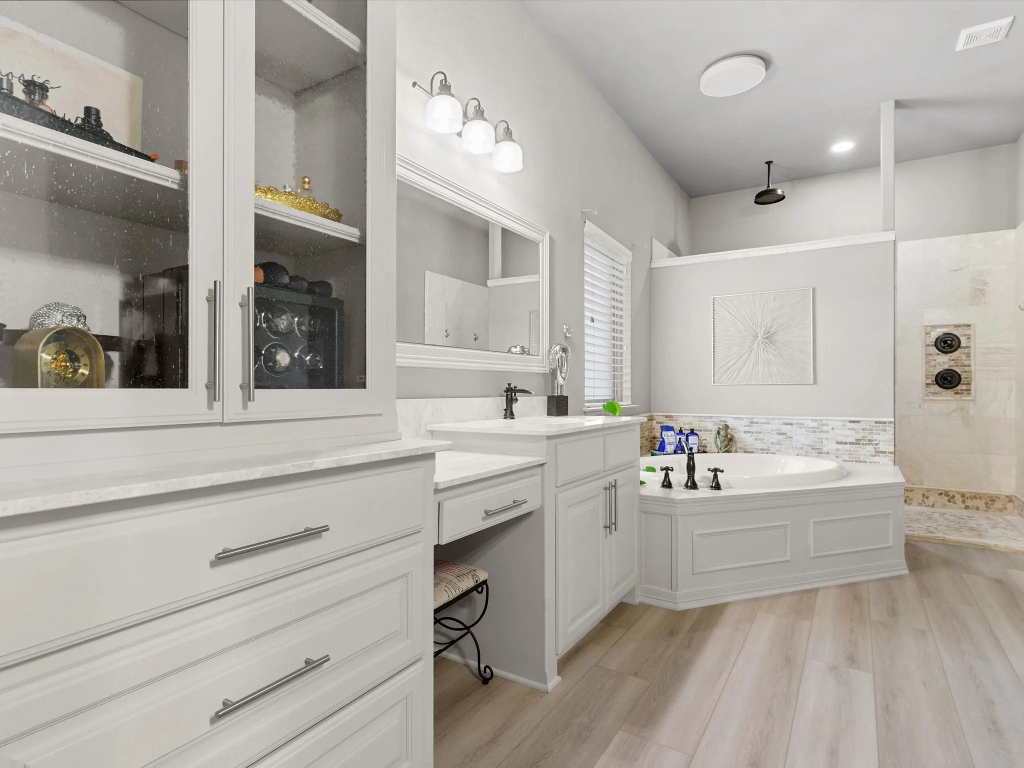 Well-appointed primary bath with dual vanities, soaking tub, and separate shower.