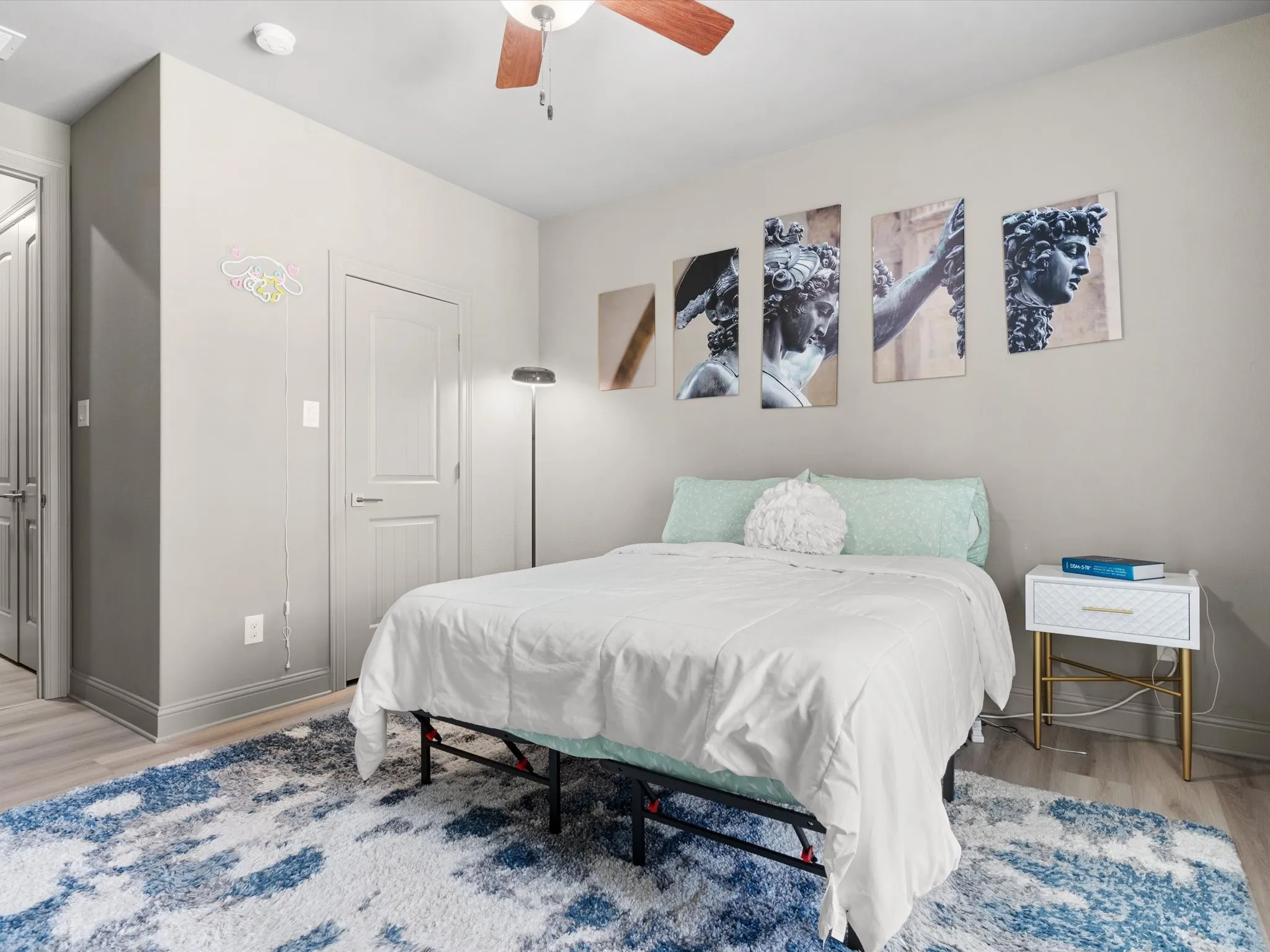 Comfortable secondary bedroom with updated lighting and ample closet space.