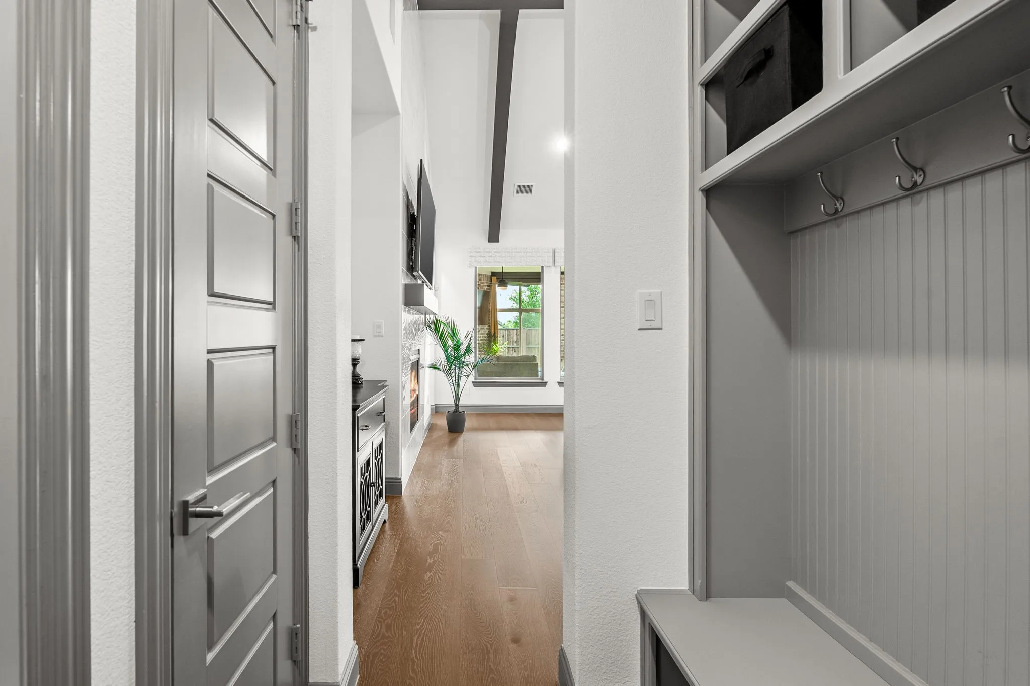 Garage Entryway #1 with built-in storage featuring beadboard paneling, integrated hooks, and upper cubbies
