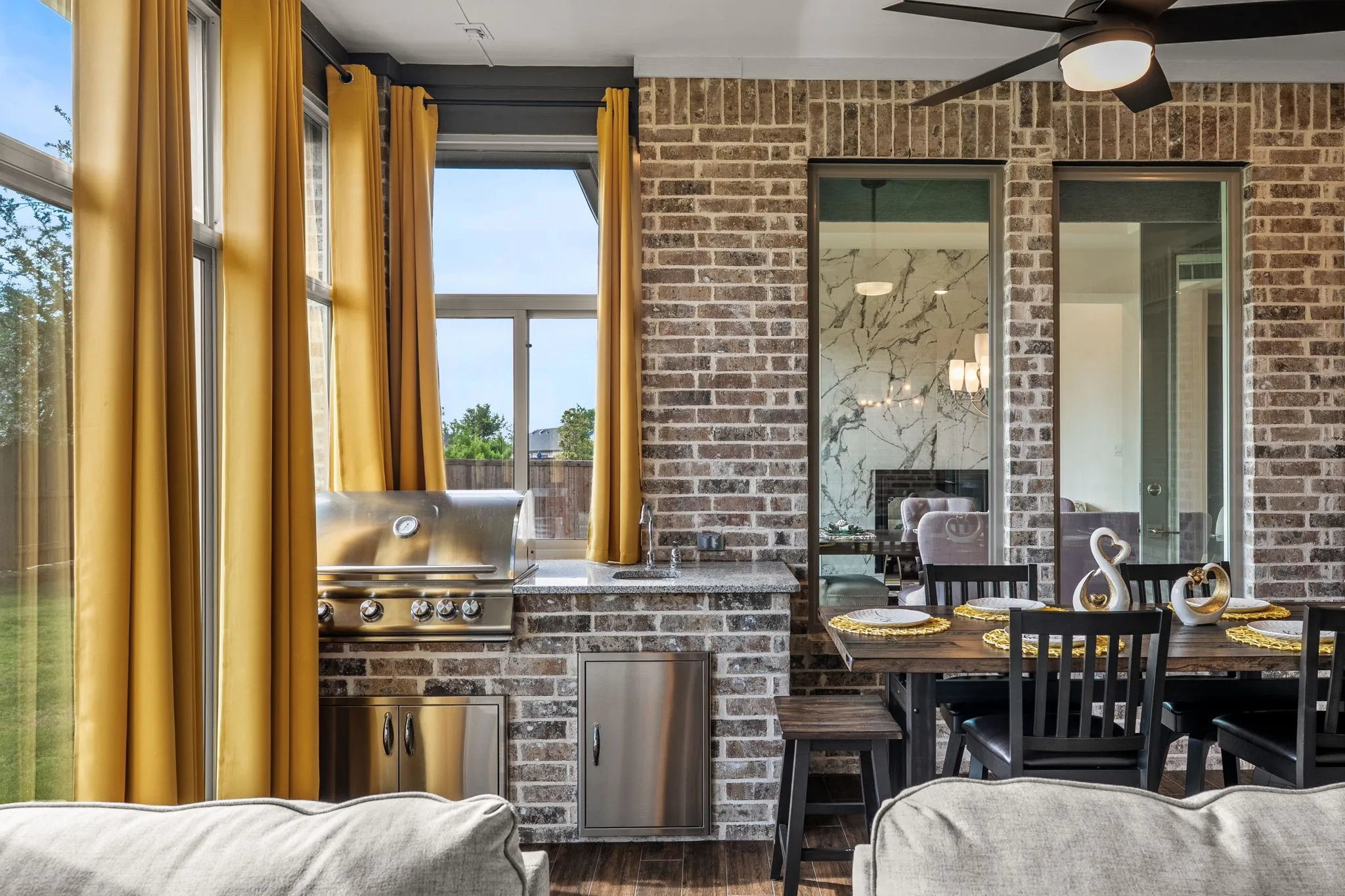 Sliding glass enclosed living space featuring HVAC, extensive brickwork, wood-finish flooring, a built-in fireplace, and expansive windows
