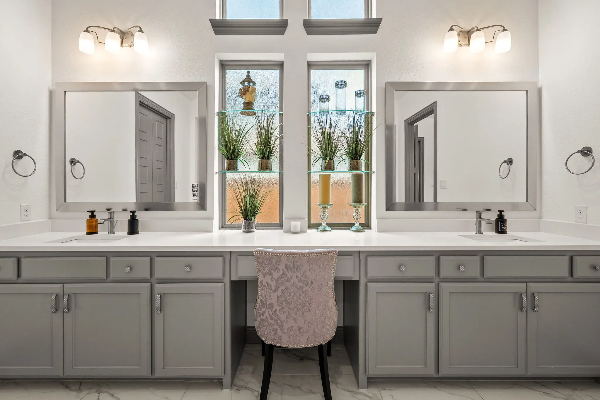 Dual vanity with integrated sinks, light gray cabinetry, and white countertops