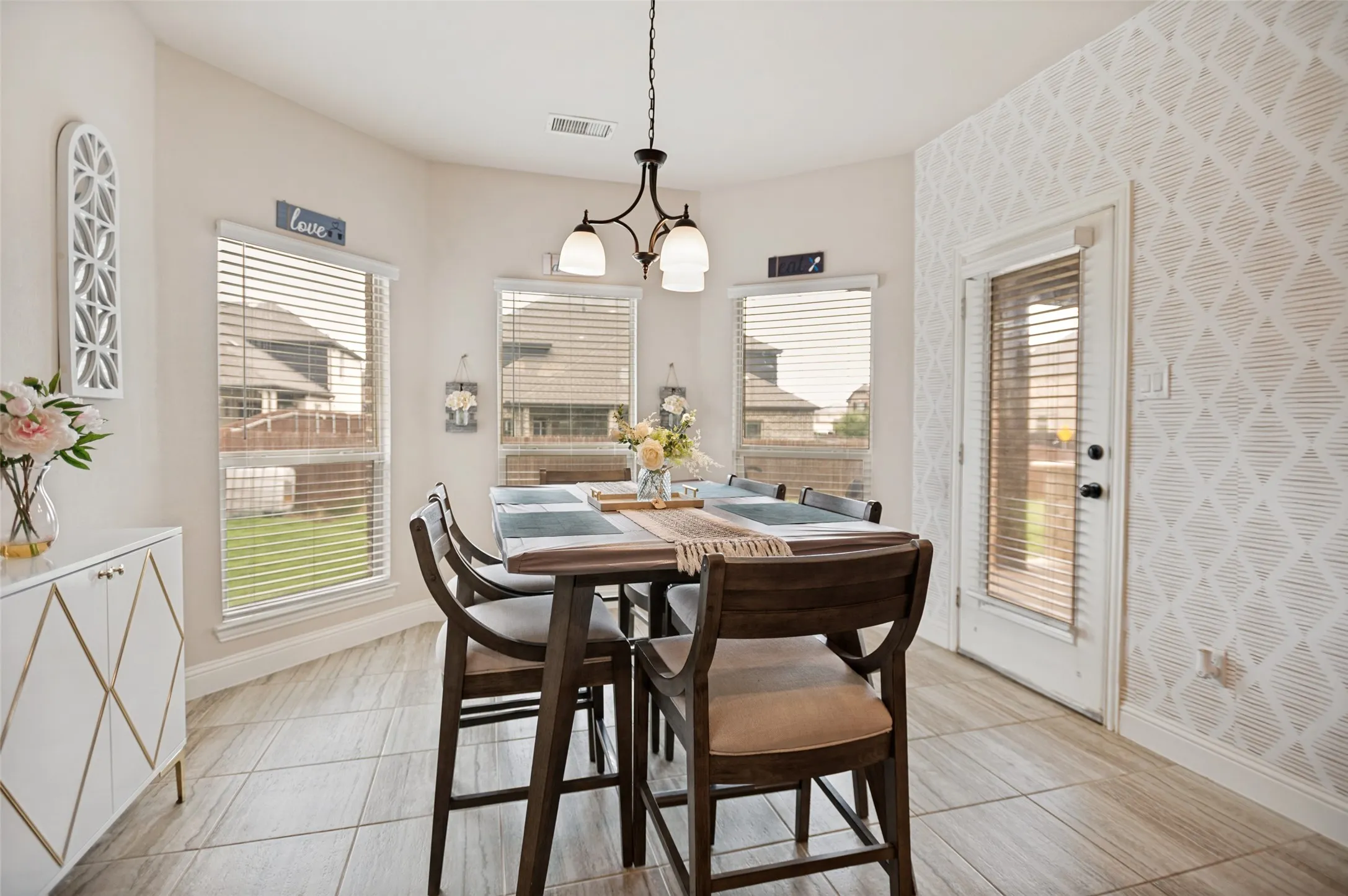 Breakfast room featuring tile flooring and a decorative accent wall