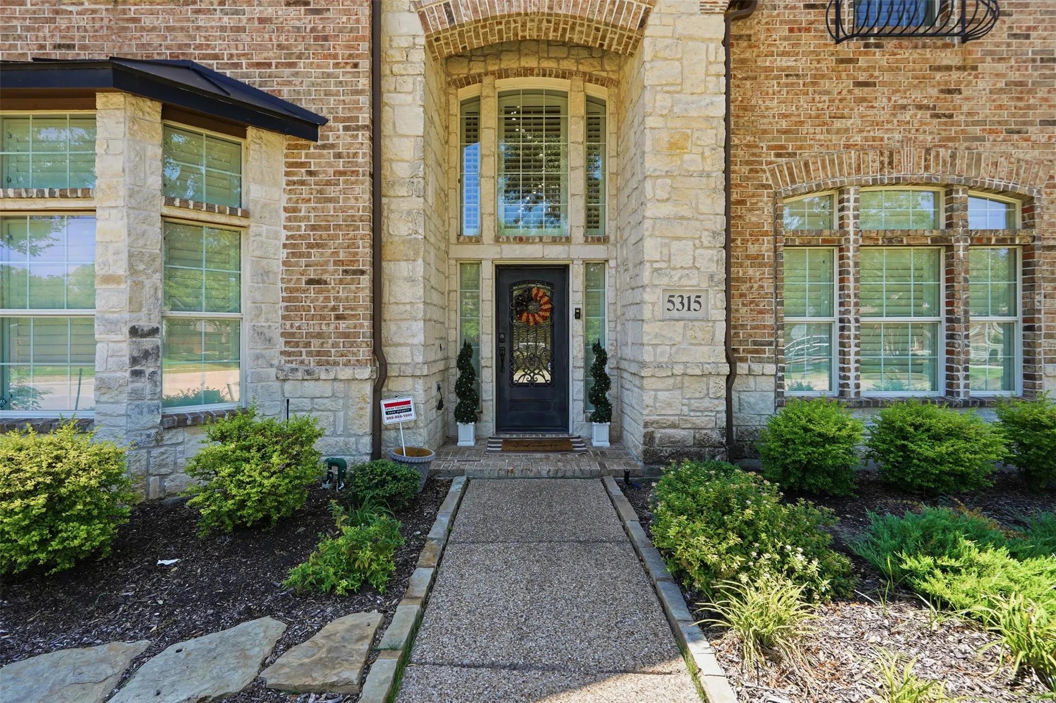 Brick and stone facade with arched entry and transom windows
