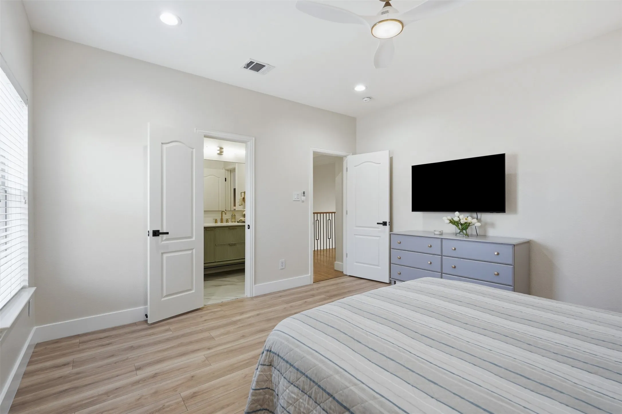 Wood-finish flooring, recessed lighting, and a ceiling fan with integrated light