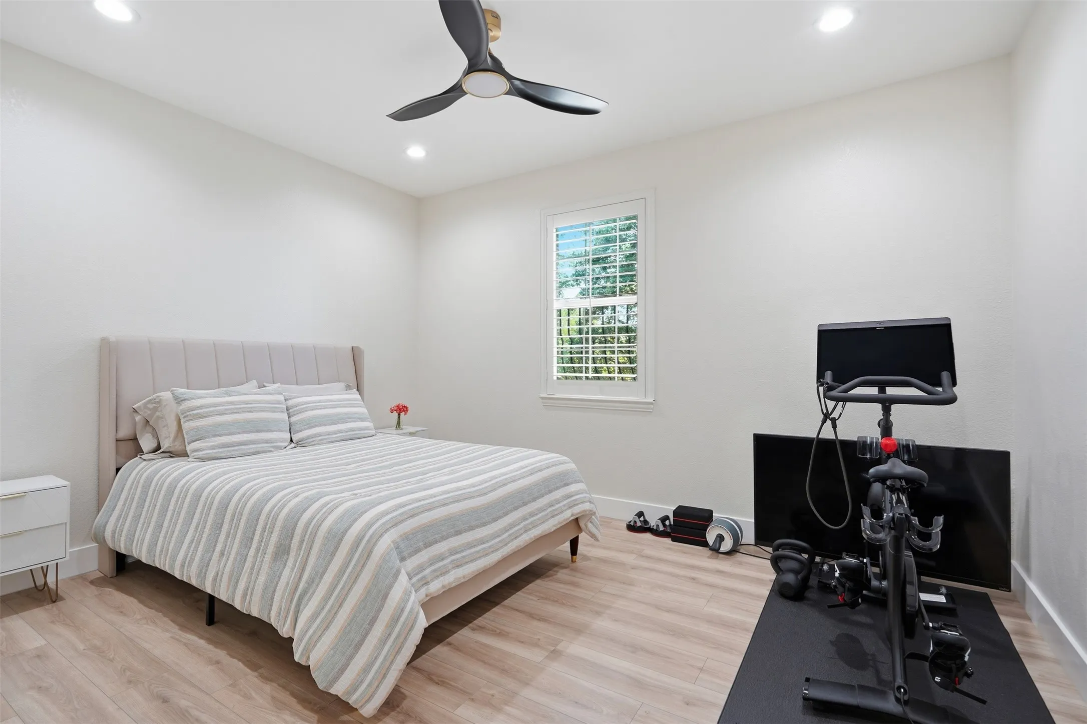 Recessed lighting, wood-finish flooring, ceiling fan, and window with plantation shutters