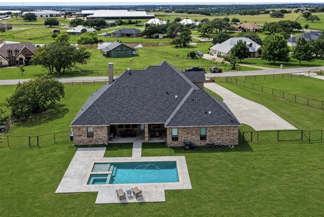 Drone image of property with AI enhanced grass.