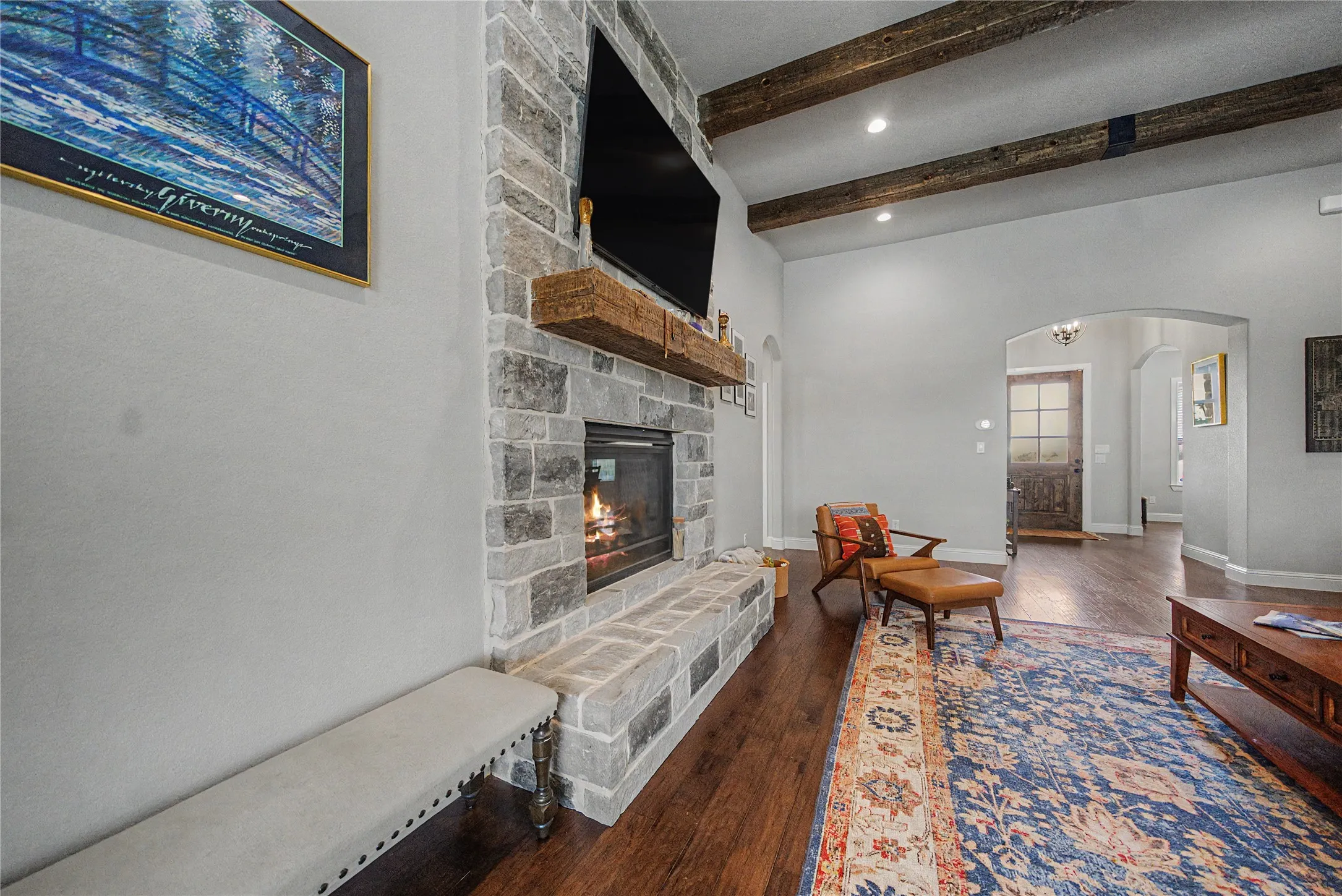 Stone-clad fireplace with a substantial hearth and wood mantel