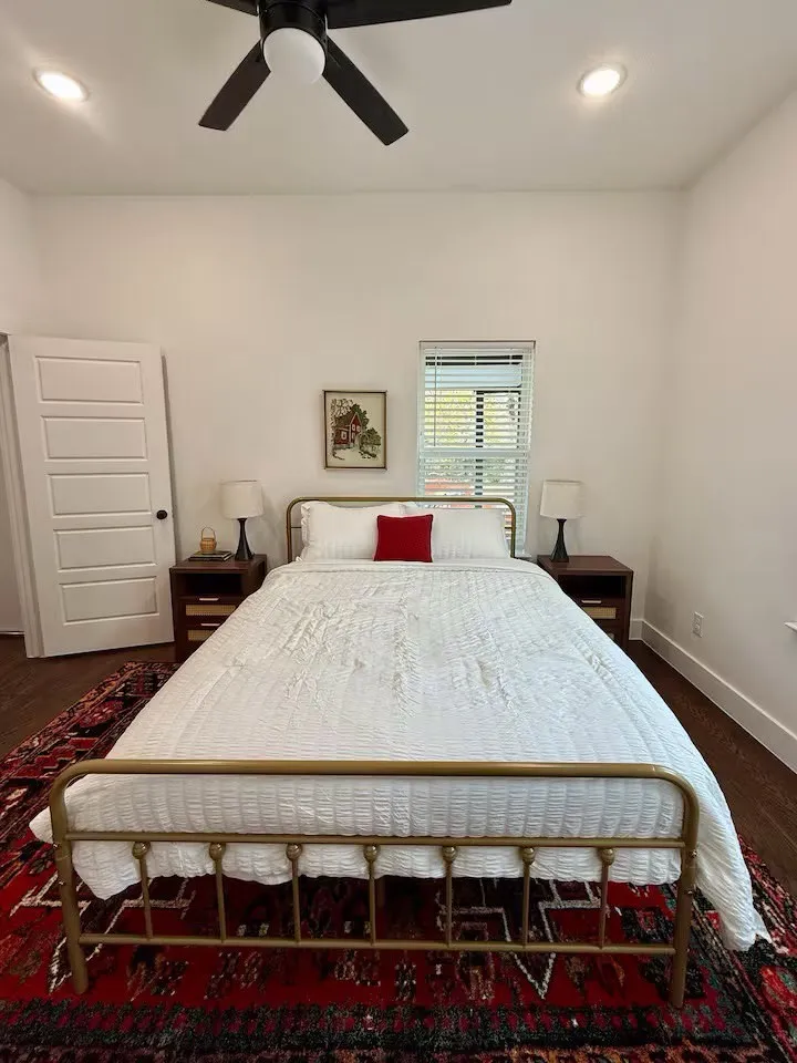 Spacious room featuring wood-finish flooring, recessed lighting, and a ceiling fan