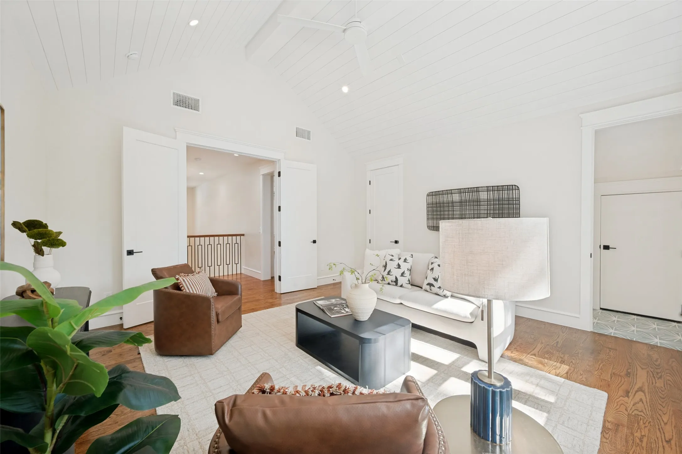 Vaulted ceiling featuring white tongue-and-groove paneling