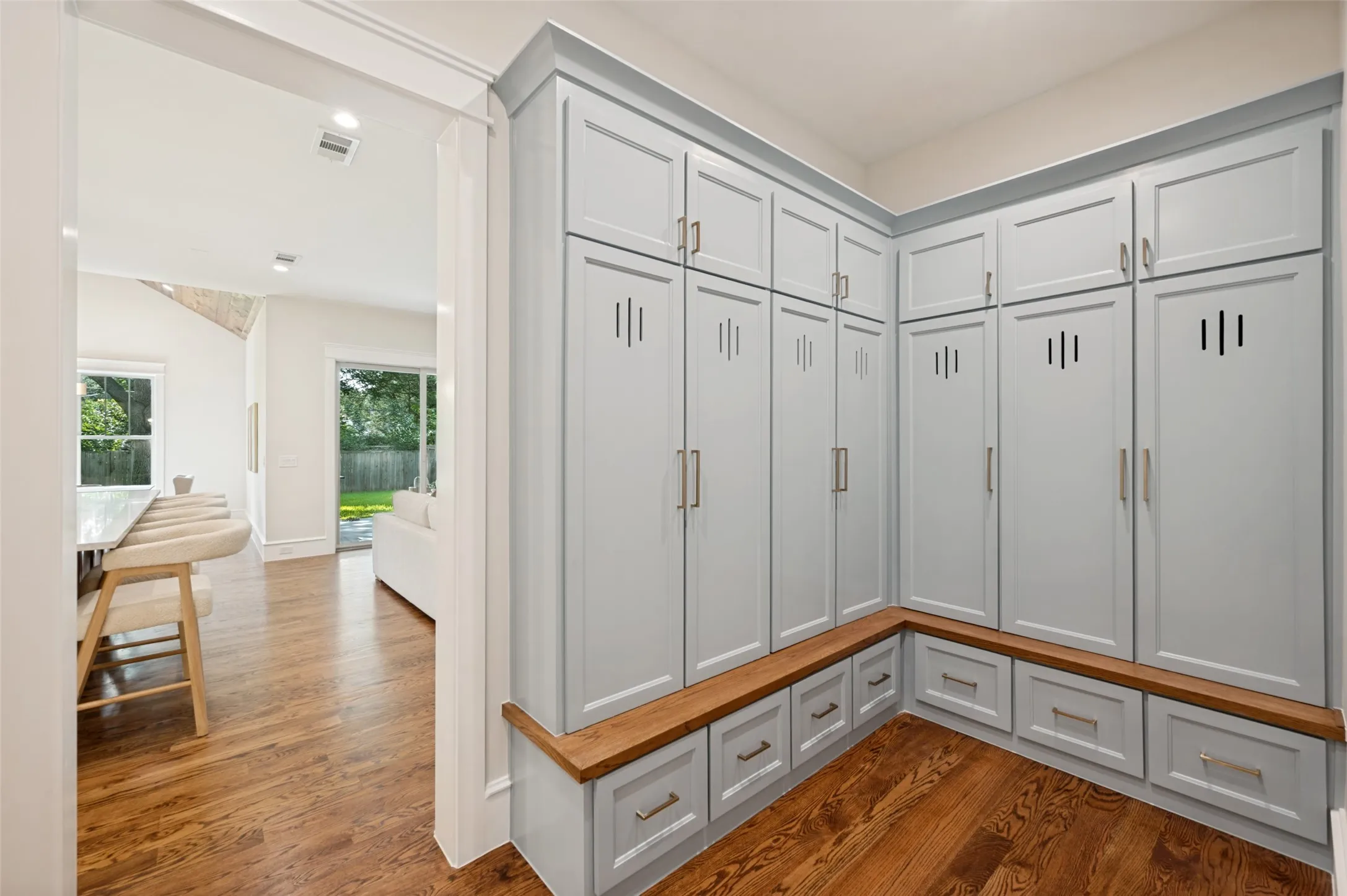 Built-in cabinetry featuring light blue panel doors, slotted vents, and brushed nickel hardware
