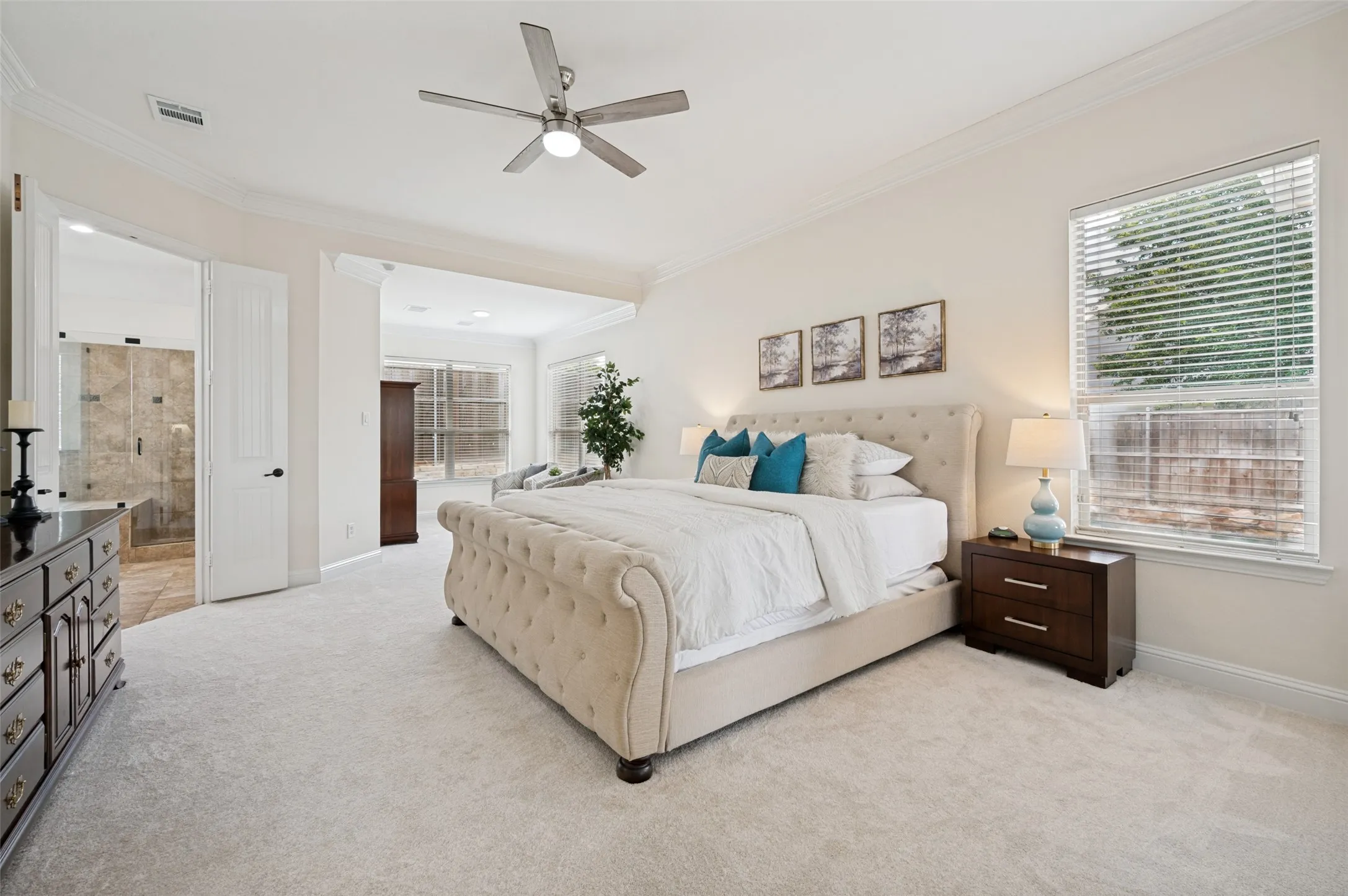 Split bedrooms allow for plenty of privacy.  This spacious Owner's suite has a sitting or reading area, beautiful views of the pool and a door to the patio for your furry friends.