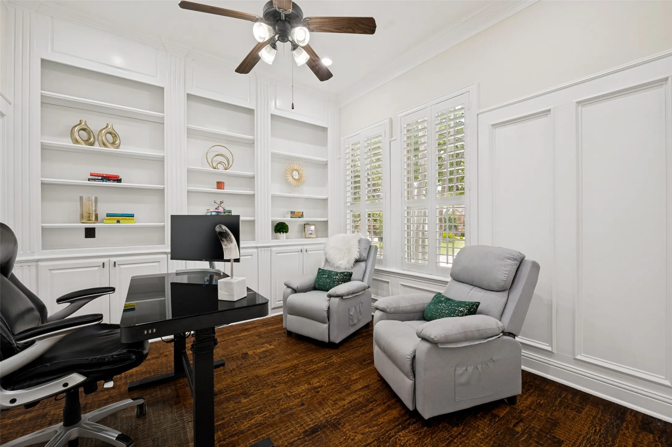 A private home office with french doors for privacy and plenty of storage.