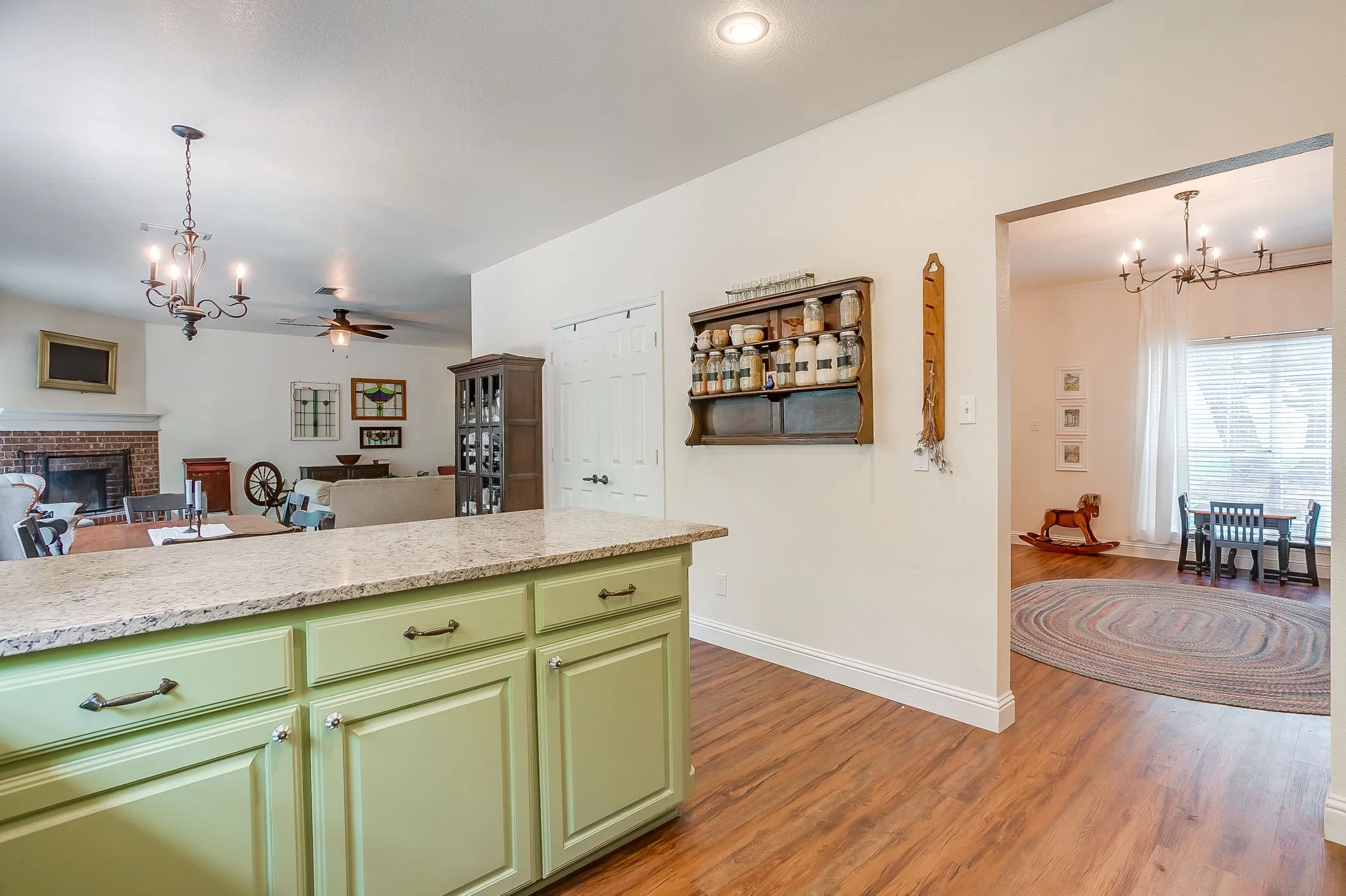 Kitchen island with light green cabinetry and a light-colored countertop