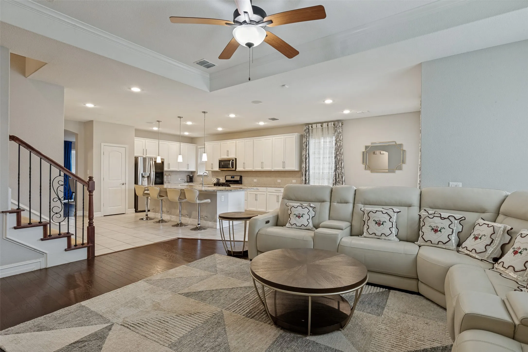 Open-concept living area with a coffered ceiling and a ceiling fan