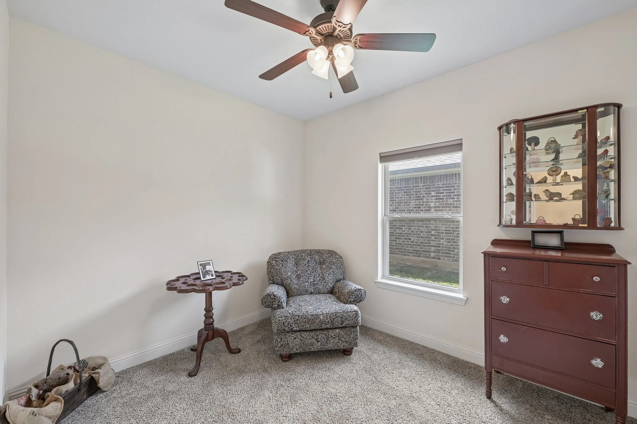 Neutral-toned wall space with gray carpet flooring