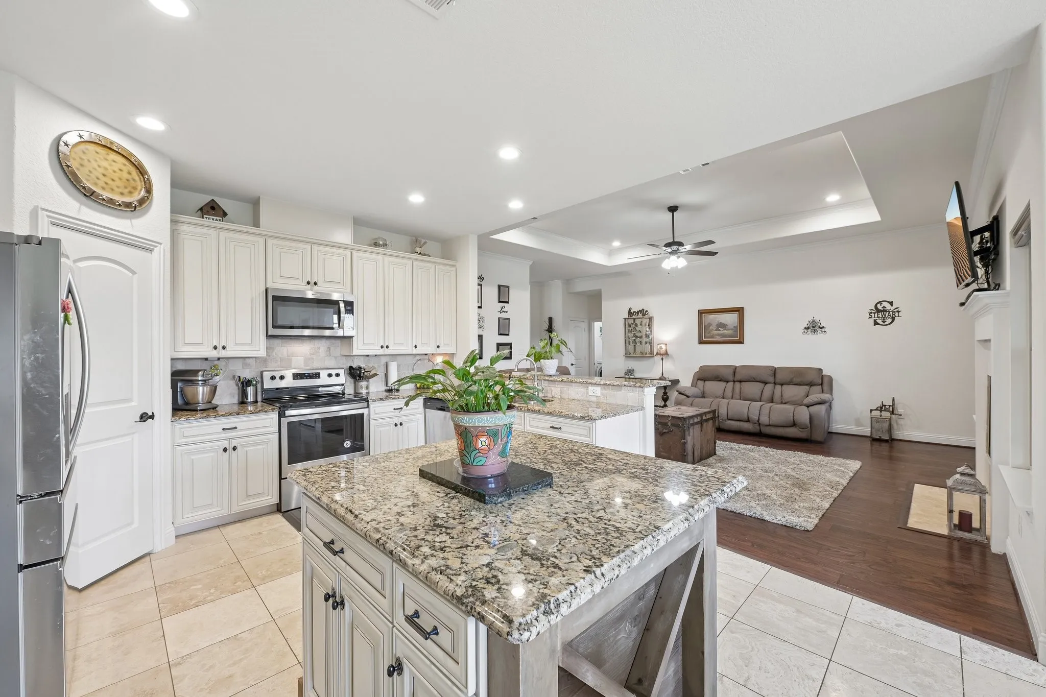 Kitchen featuring a large island with granite countertop, shaker-style cabinetry, and stainless steel appliances