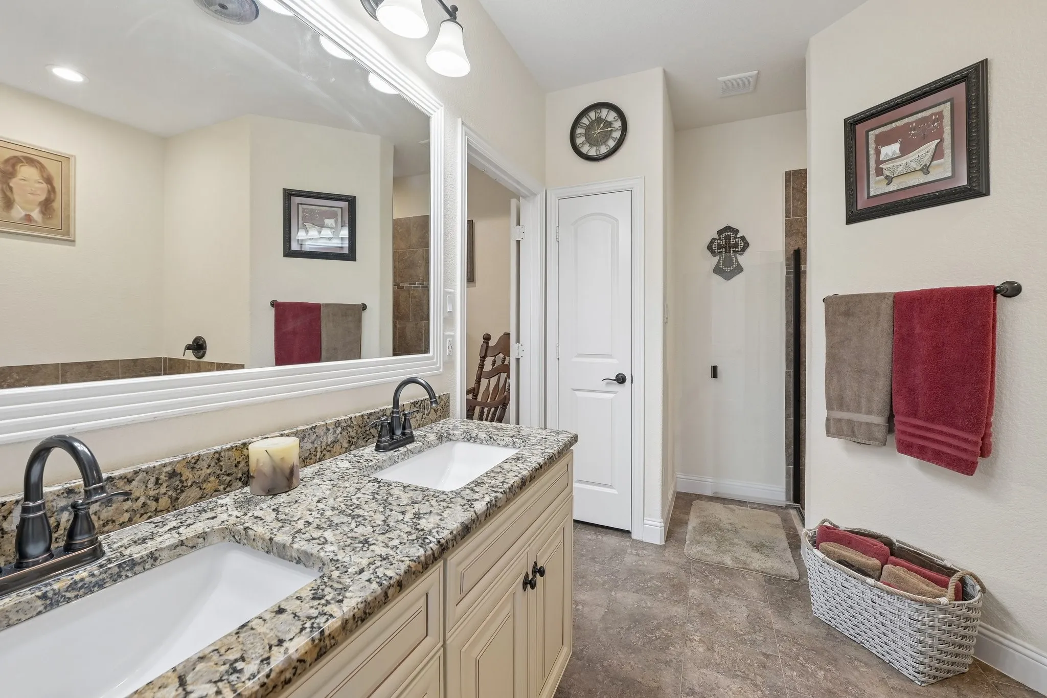 Dual vanity featuring granite countertops and undermount sinks with oil-rubbed bronze fixtures