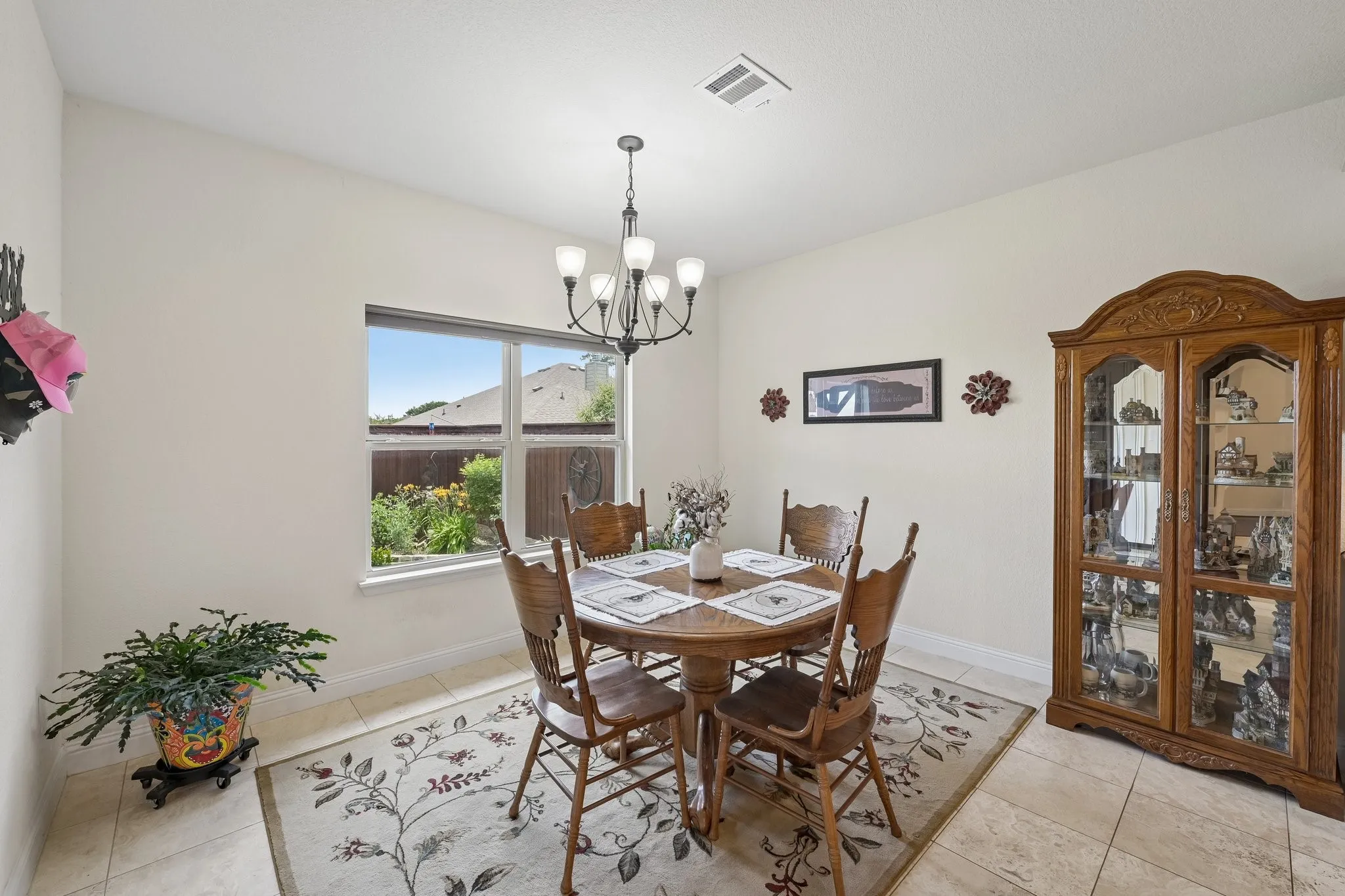 Dining area with tile flooring and a window overlooking exterior landscaping