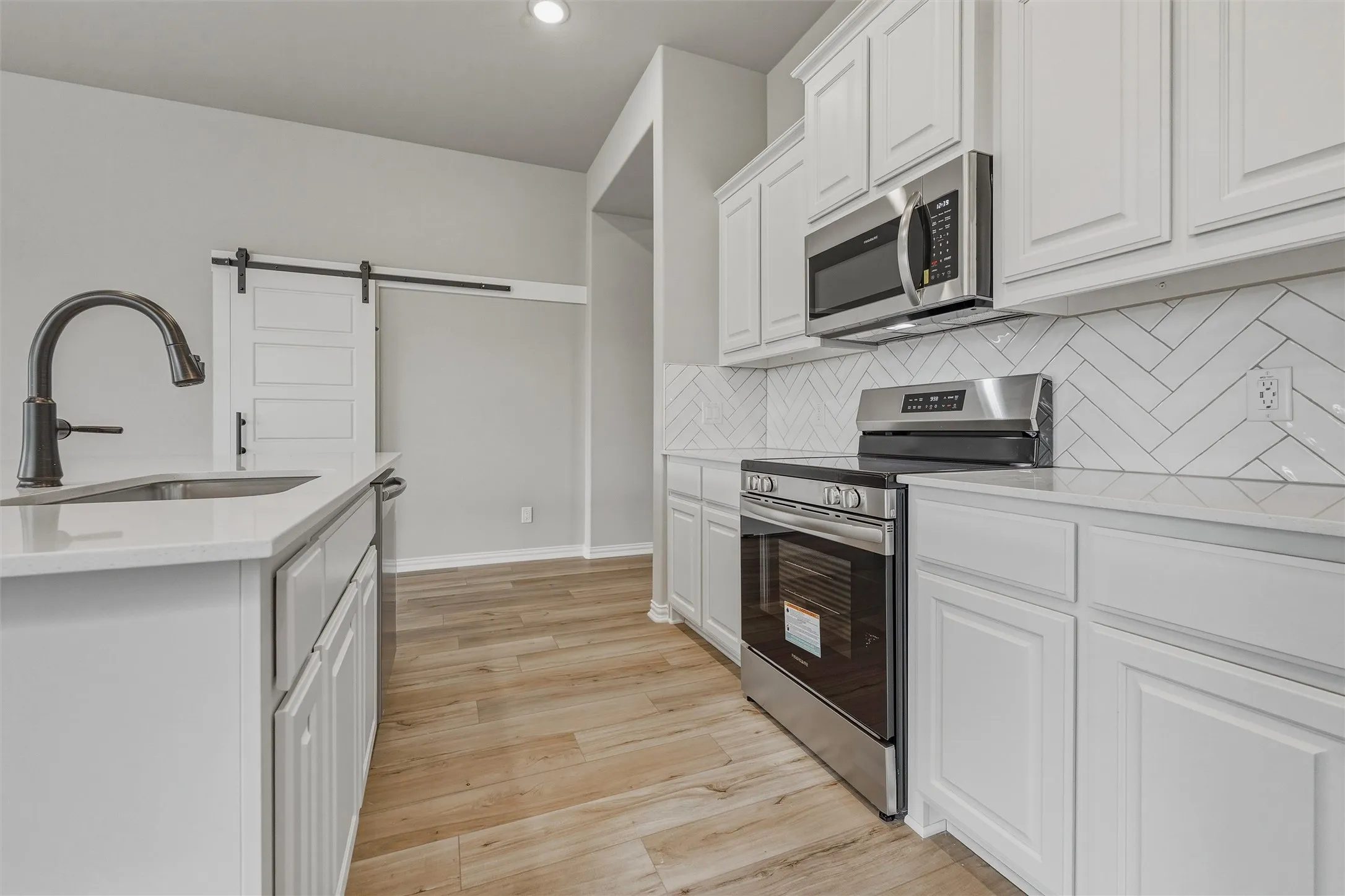 White cabinetry and light wood-finish flooring