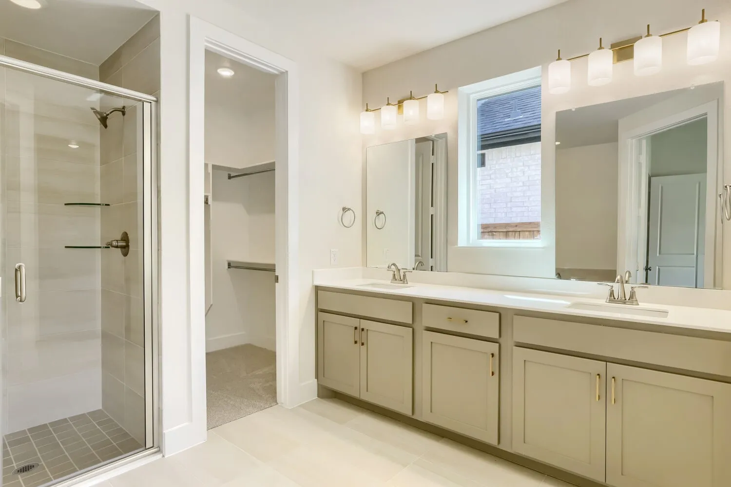 Dual vanity with light-colored cabinetry and countertop