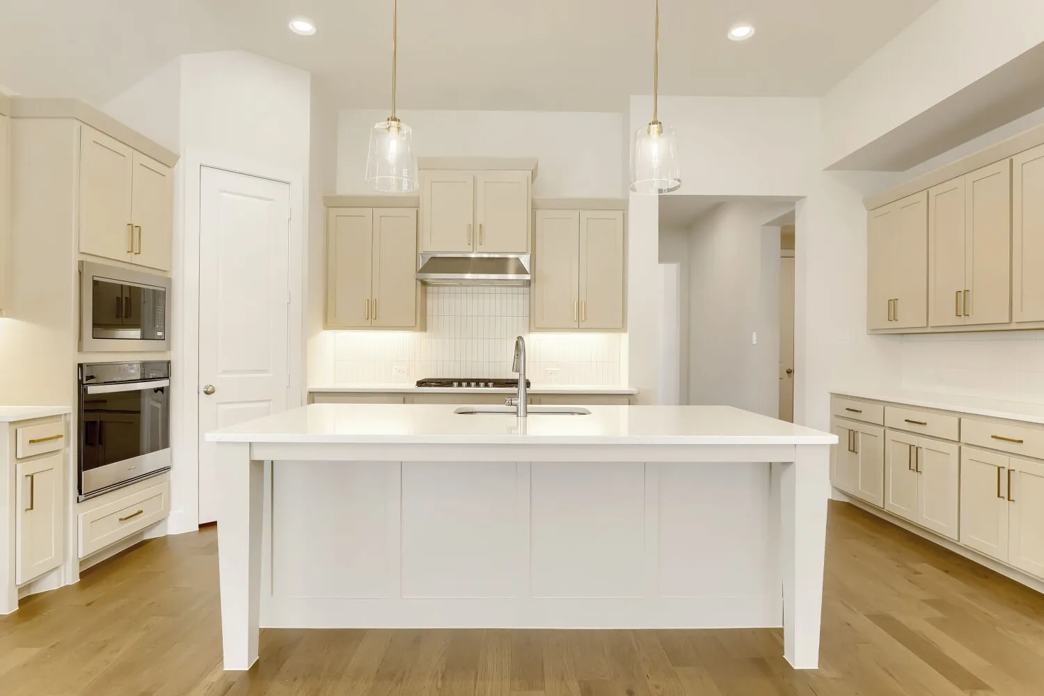 Kitchen featuring wood-finish flooring, a central island with countertop, and recessed lighting