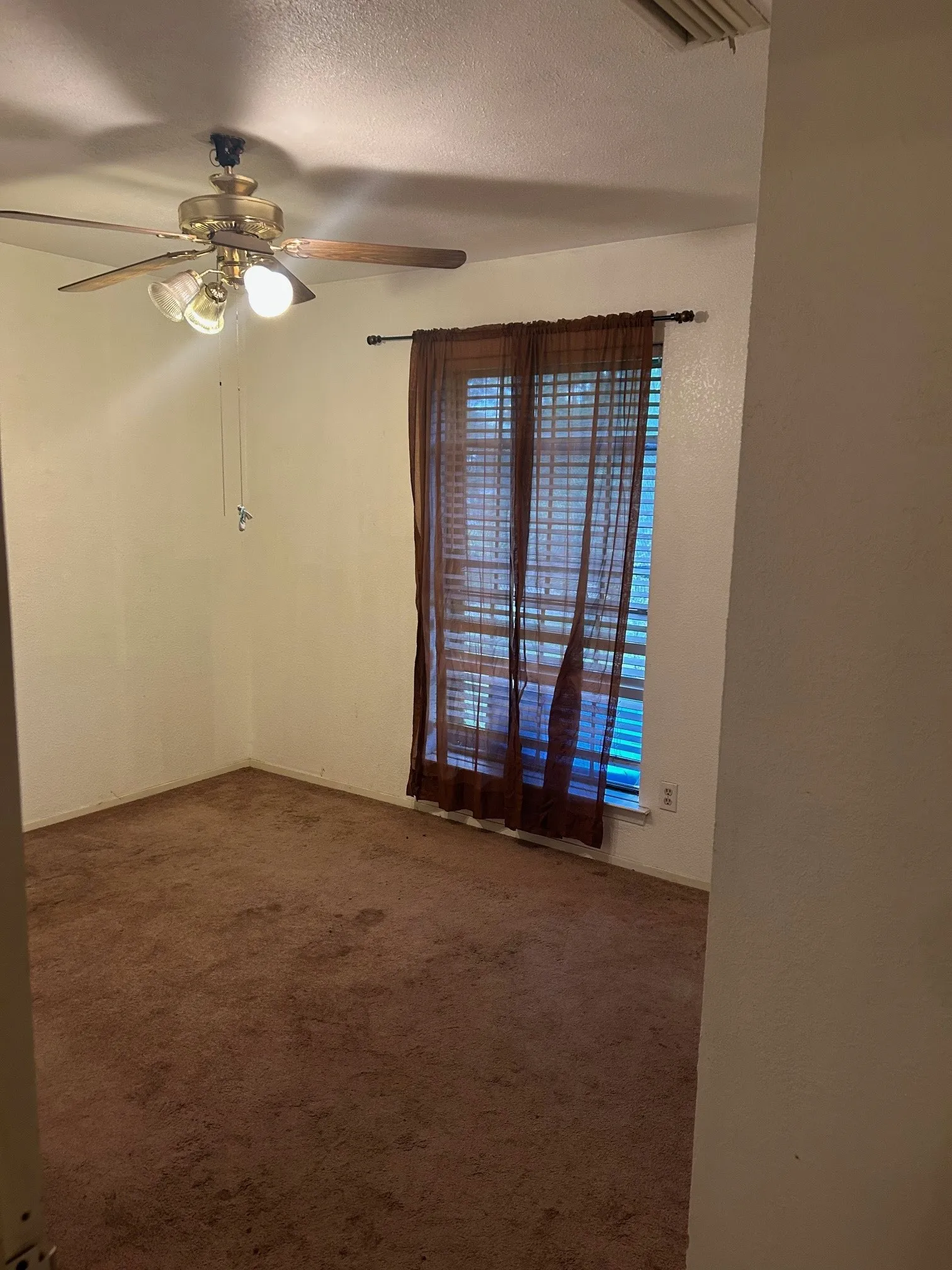 Bedroom #3 Carpeted interior space featuring a ceiling fan with integrated lighting, a window with horizontal blinds.