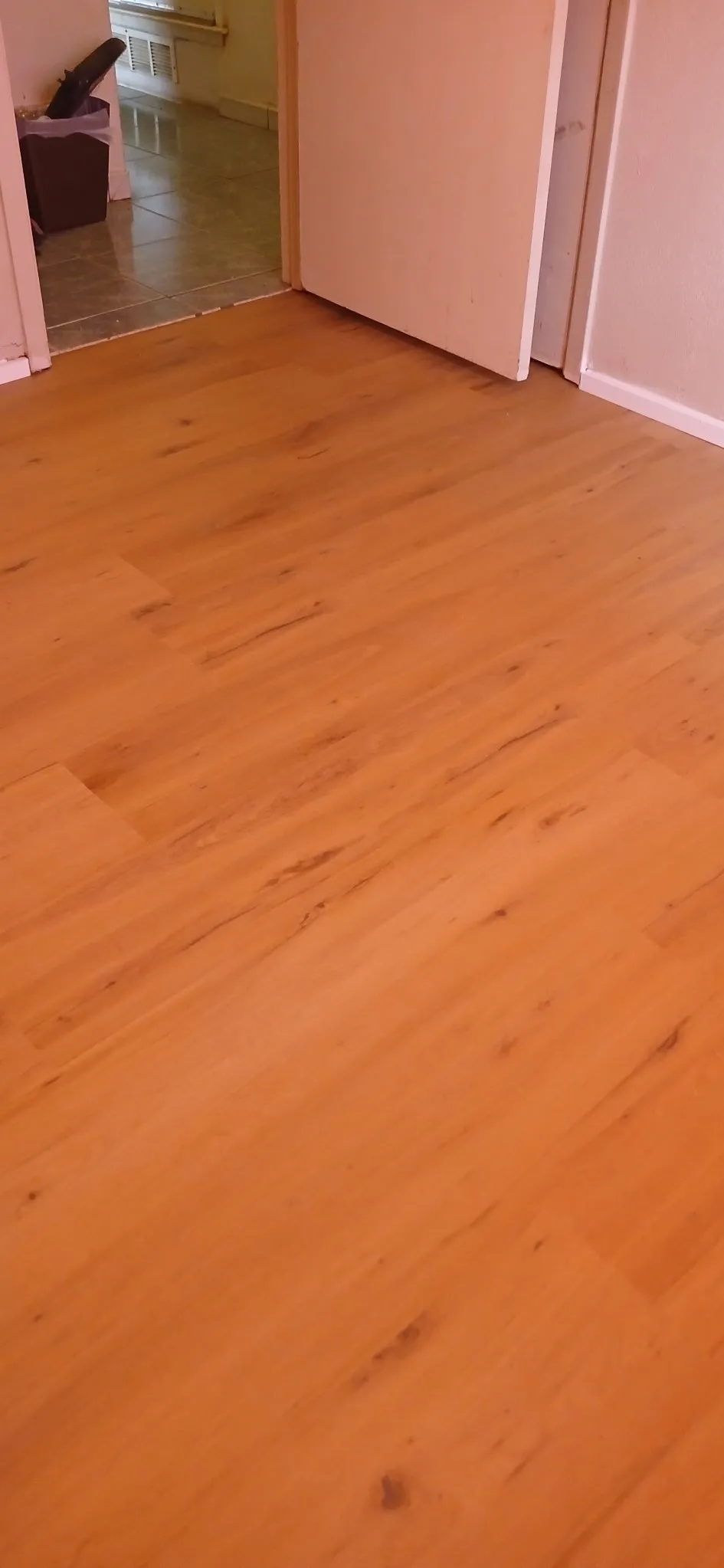 Newly installed Wood-finish flooring with varied plank patterns