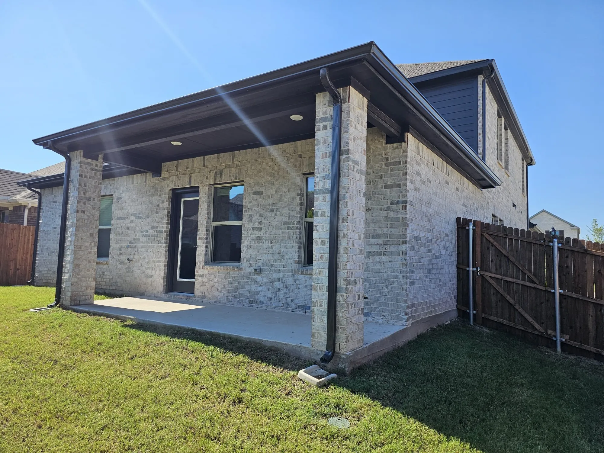 Rear view of property featuring a patio and a yard