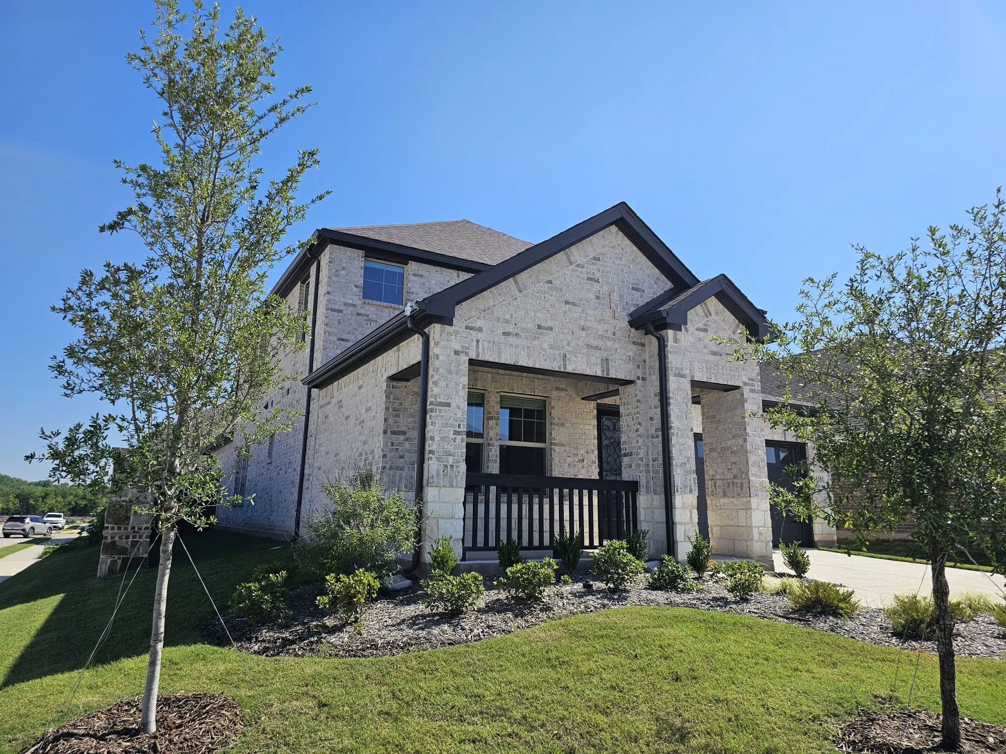 View of front of property featuring covered porch and a front lawn