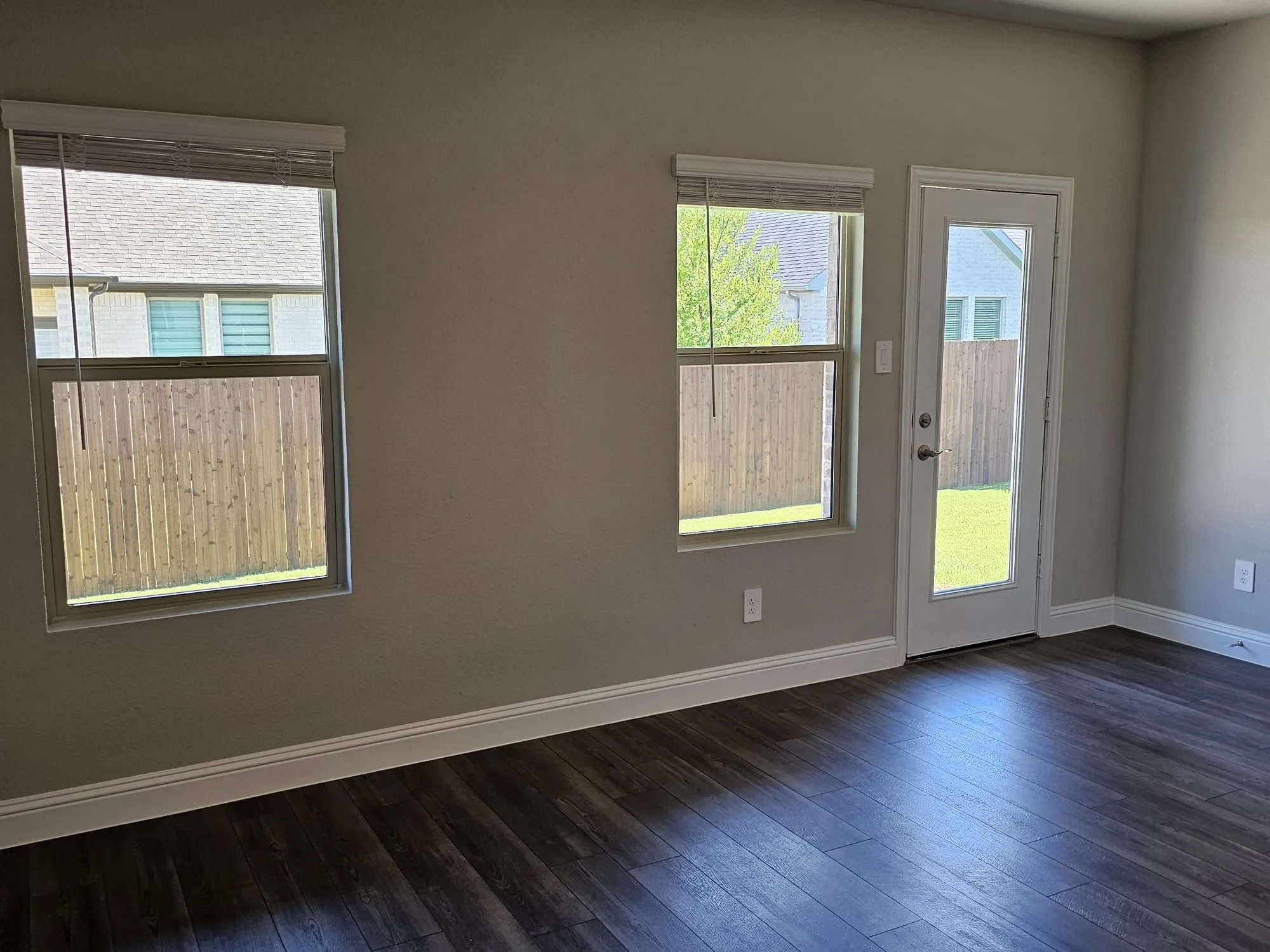 Empty room with dark wood-type flooring