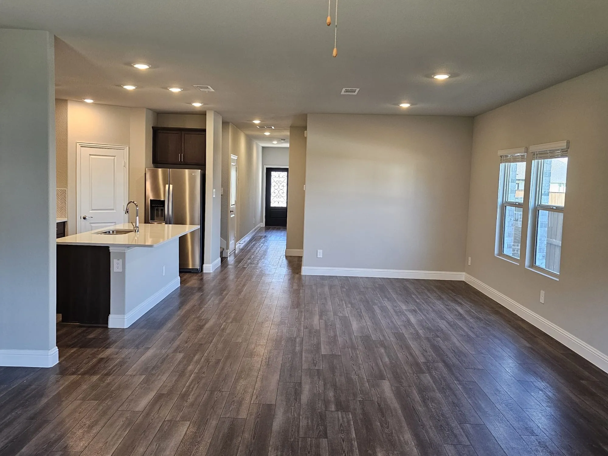Kitchen featuring sink, dark hardwood / wood-style floors, dark brown cabinets, and a wealth of natural light