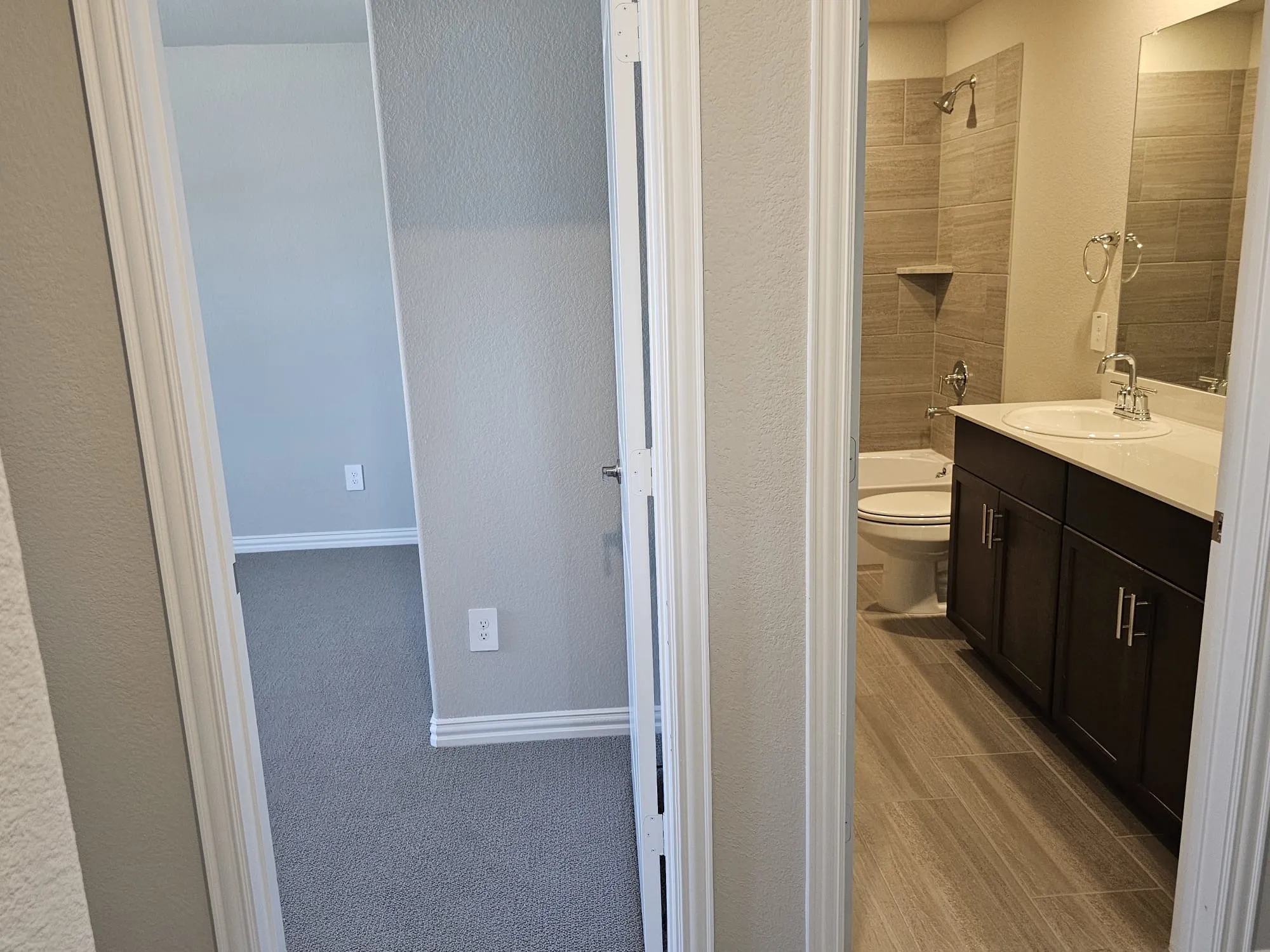 Full bathroom with tiled shower / bath, vanity, and toilet