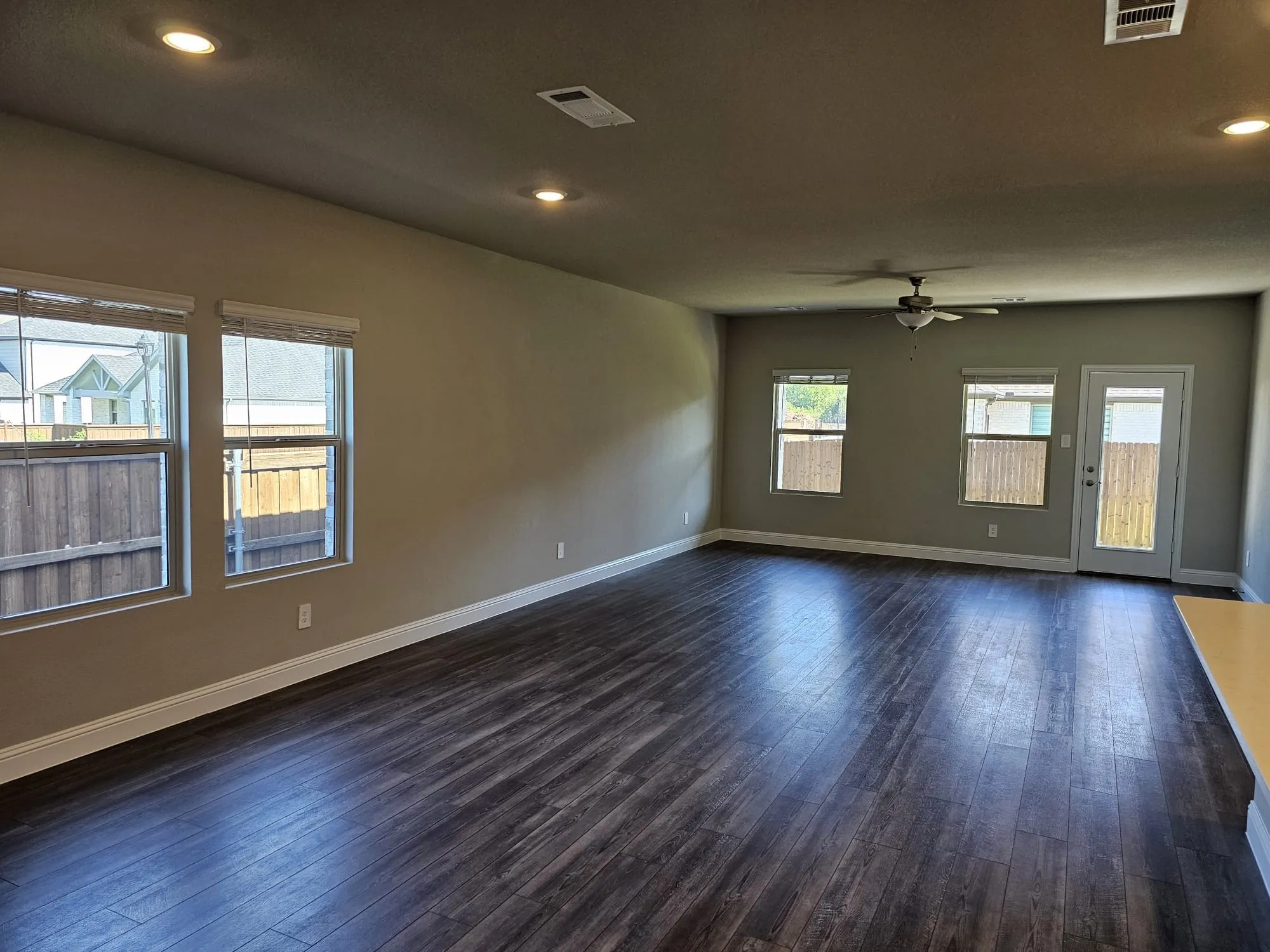Unfurnished room featuring ceiling fan and dark wood-type flooring
