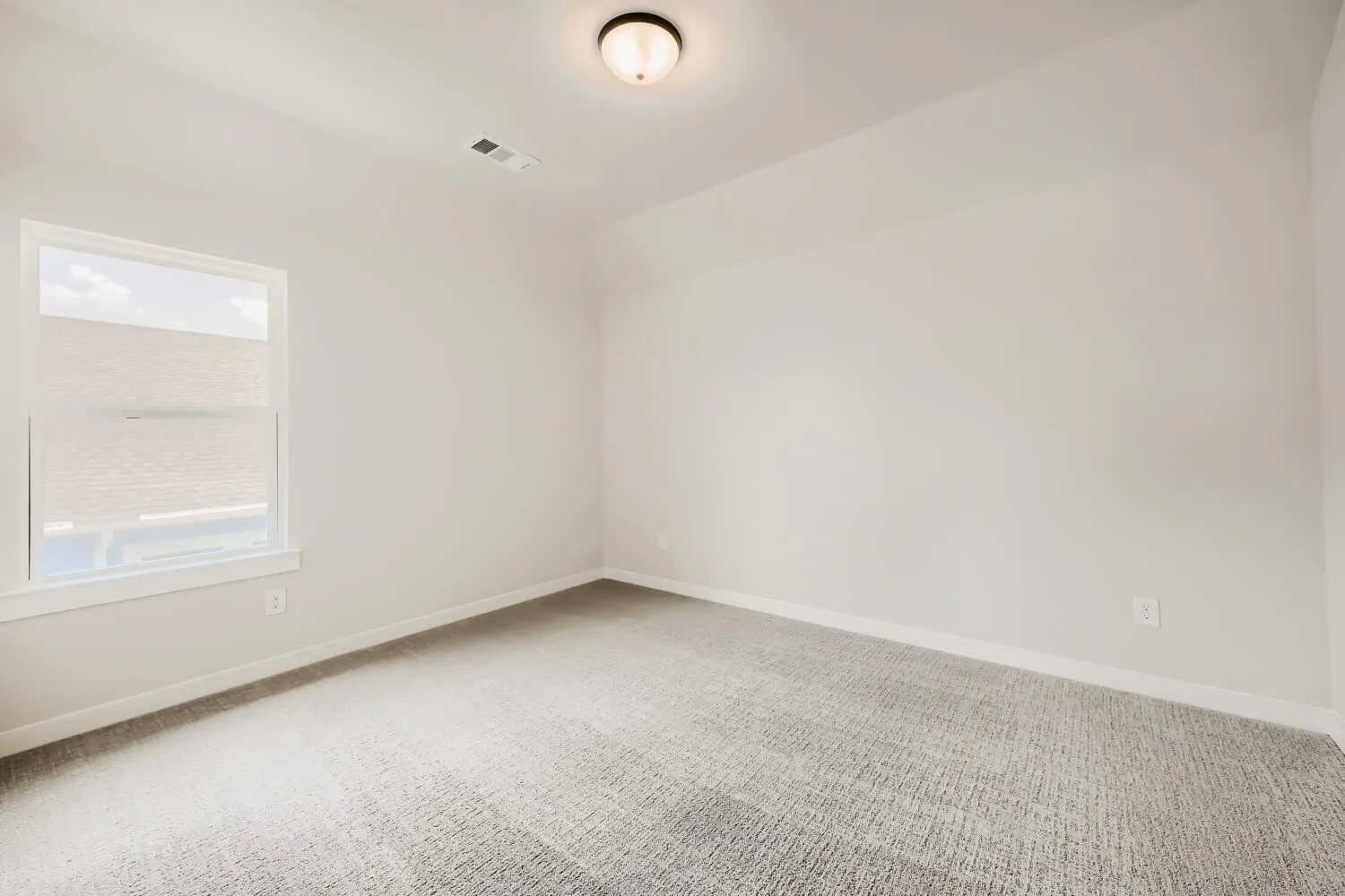 Neutral paint palette with a single window and recessed ceiling light