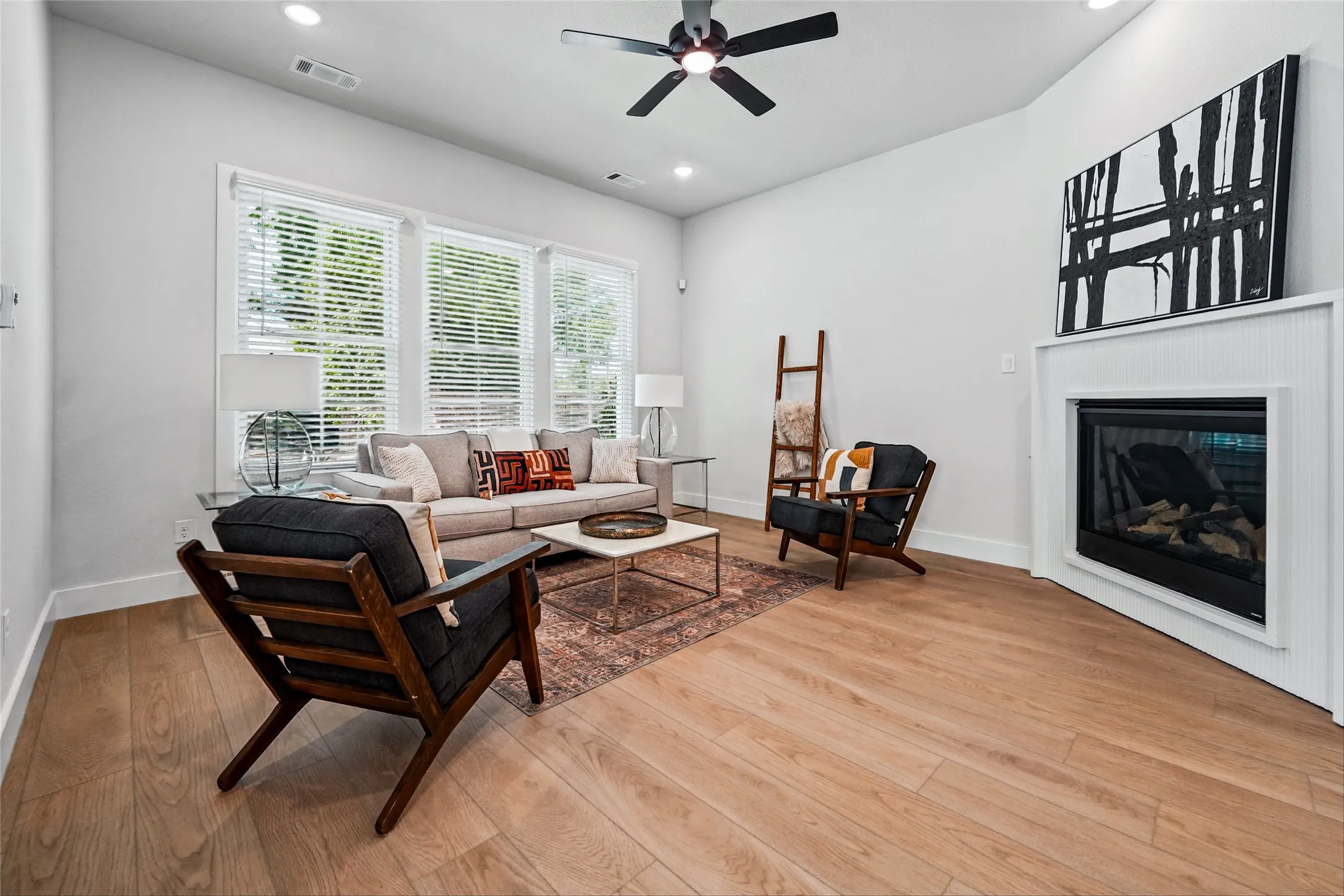 Wood-finish flooring, recessed lighting, and a modern ceiling fan