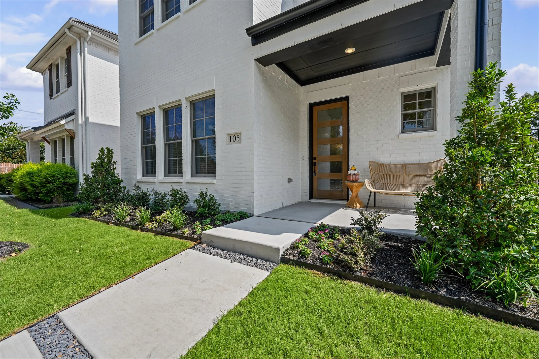 White brick exterior with a contrasting dark soffit and trim