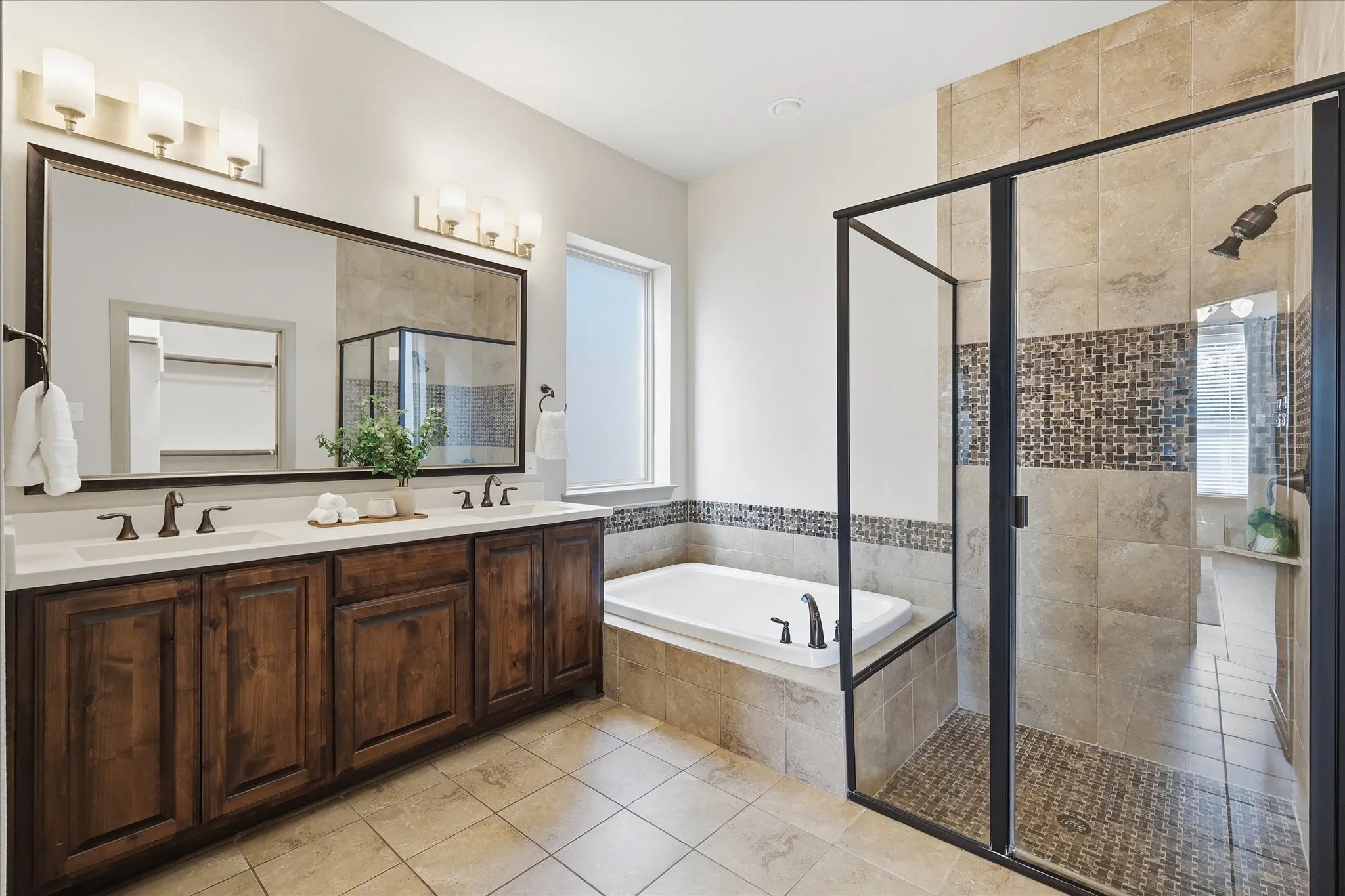 Bathroom featuring a dual vanity with wood cabinetry and white countertops