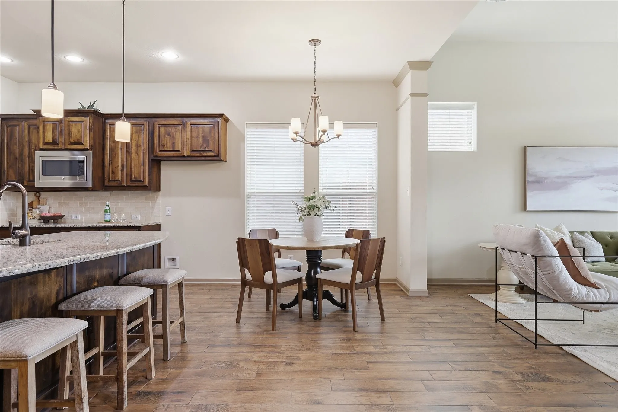 Open-concept living space featuring wood-finish flooring throughout