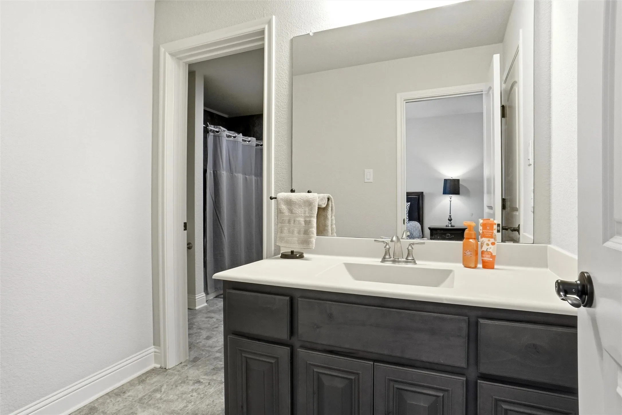 Vanity with a solid surface countertop and an integrated rectangular sink