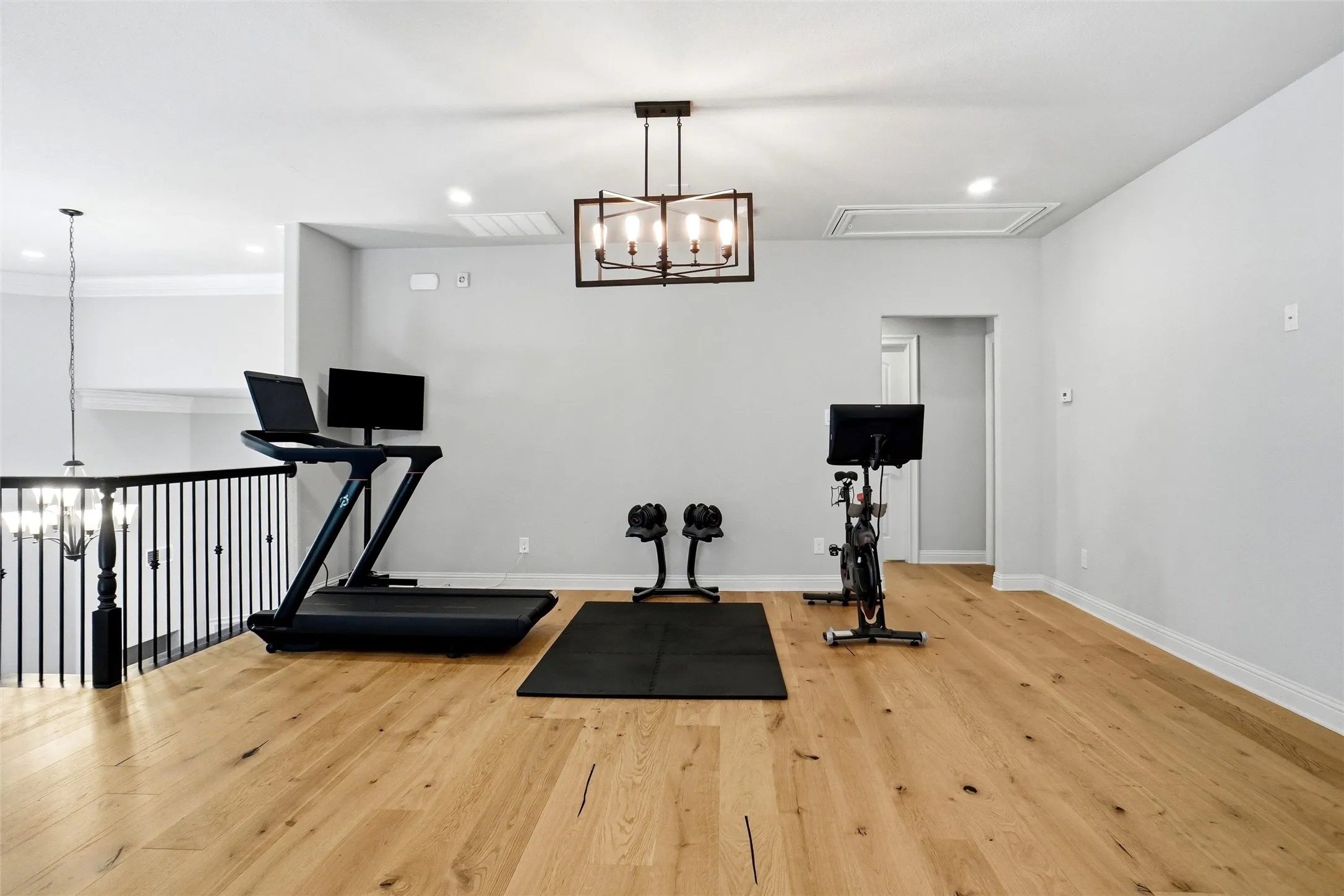 Spacious bonus room featuring light wood-finish flooring and recessed lighting