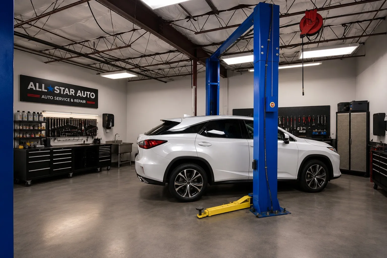 Industrial-style commercial space featuring a concrete floor, exposed ceiling joists, white painted walls, and fluorescent lighting