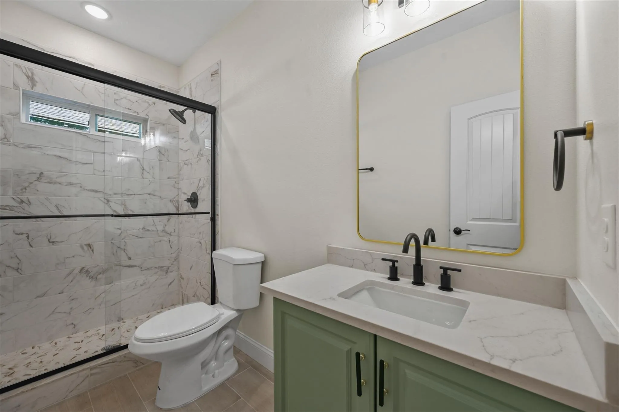 Bright interior room featuring wood-finish flooring, white baseboards, and neutral wall tones