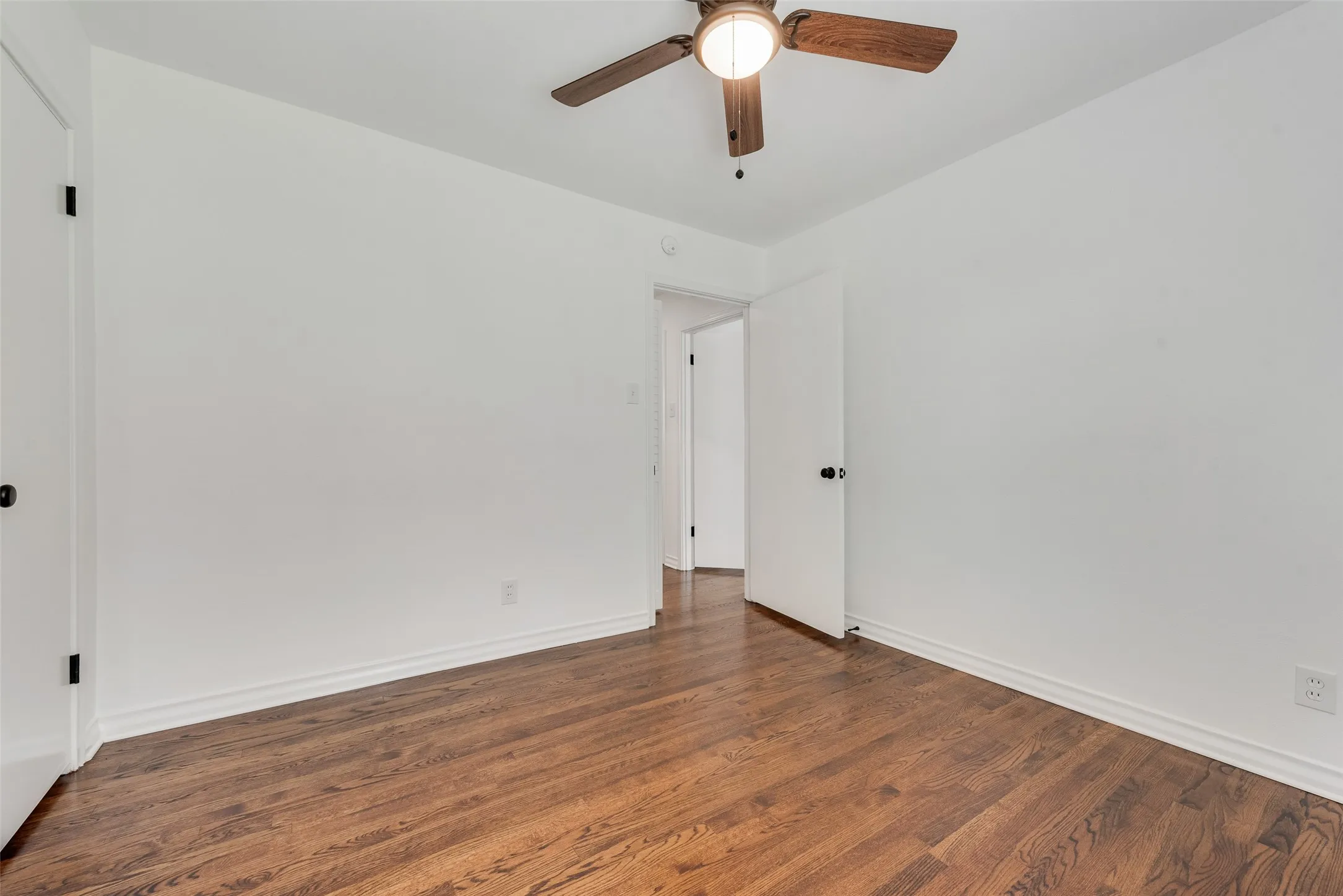 Wood-finish flooring with white baseboards