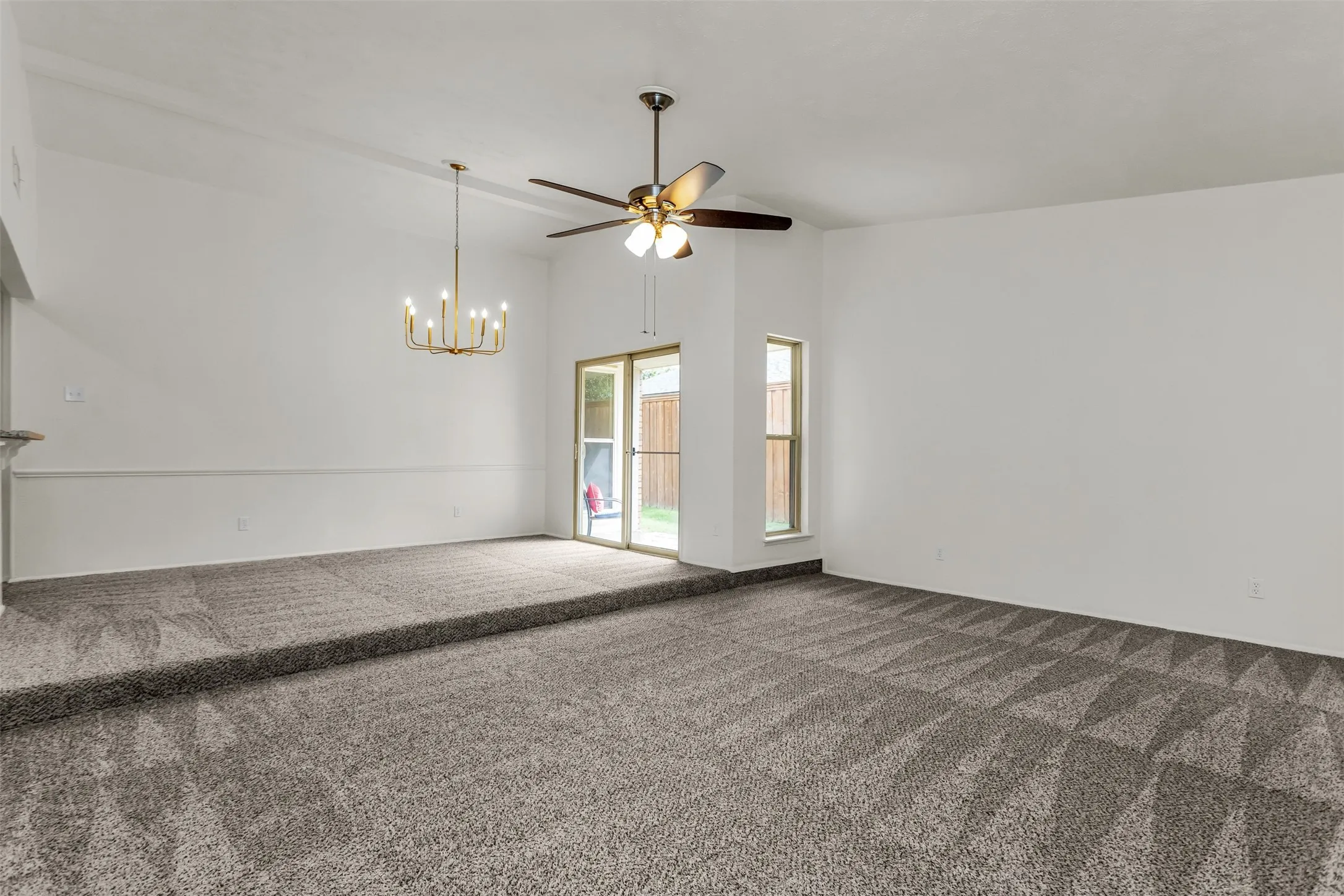 Spacious interior with multi-level carpeted flooring featuring a geometric pattern