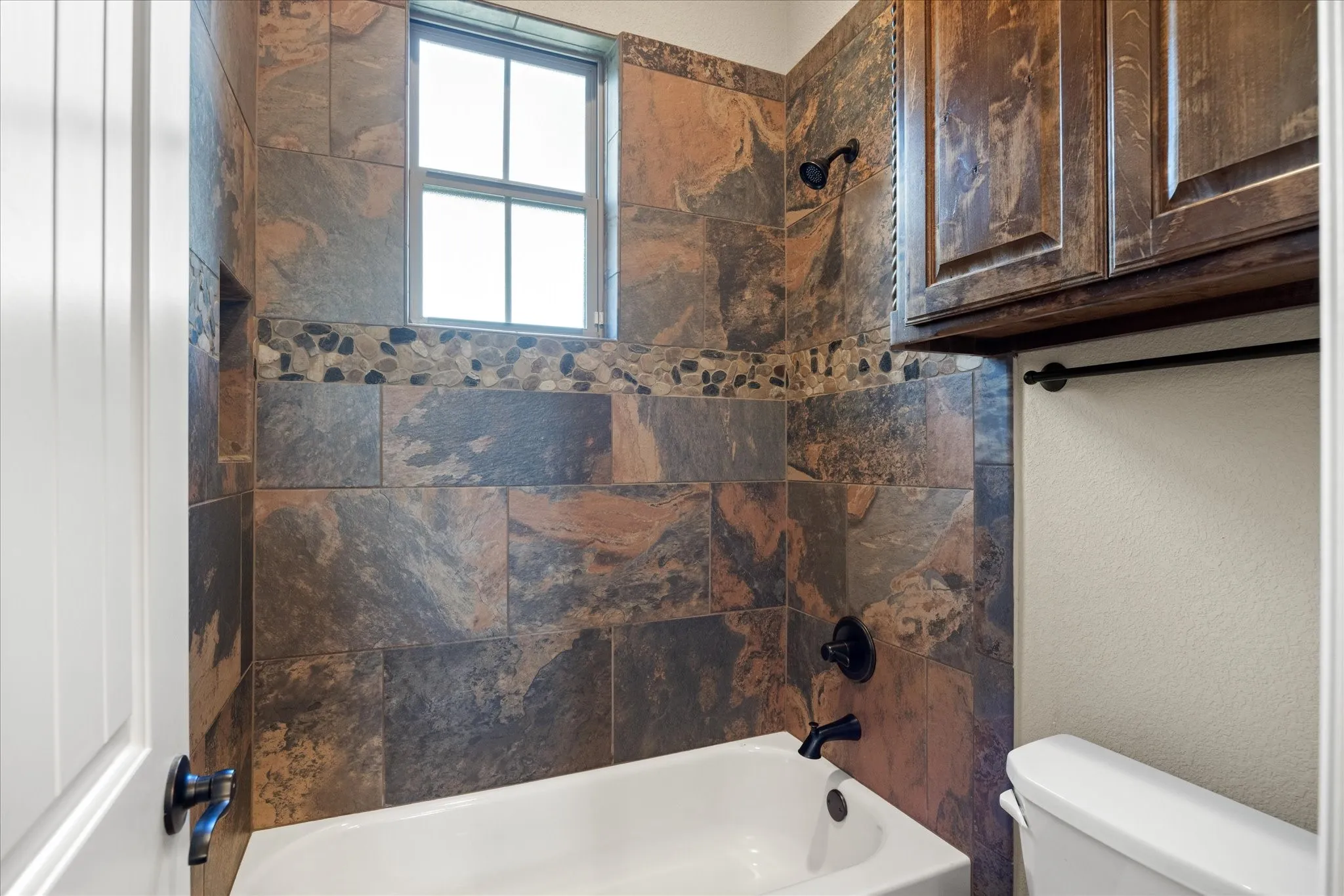 Separate water closet in shared bathroom.