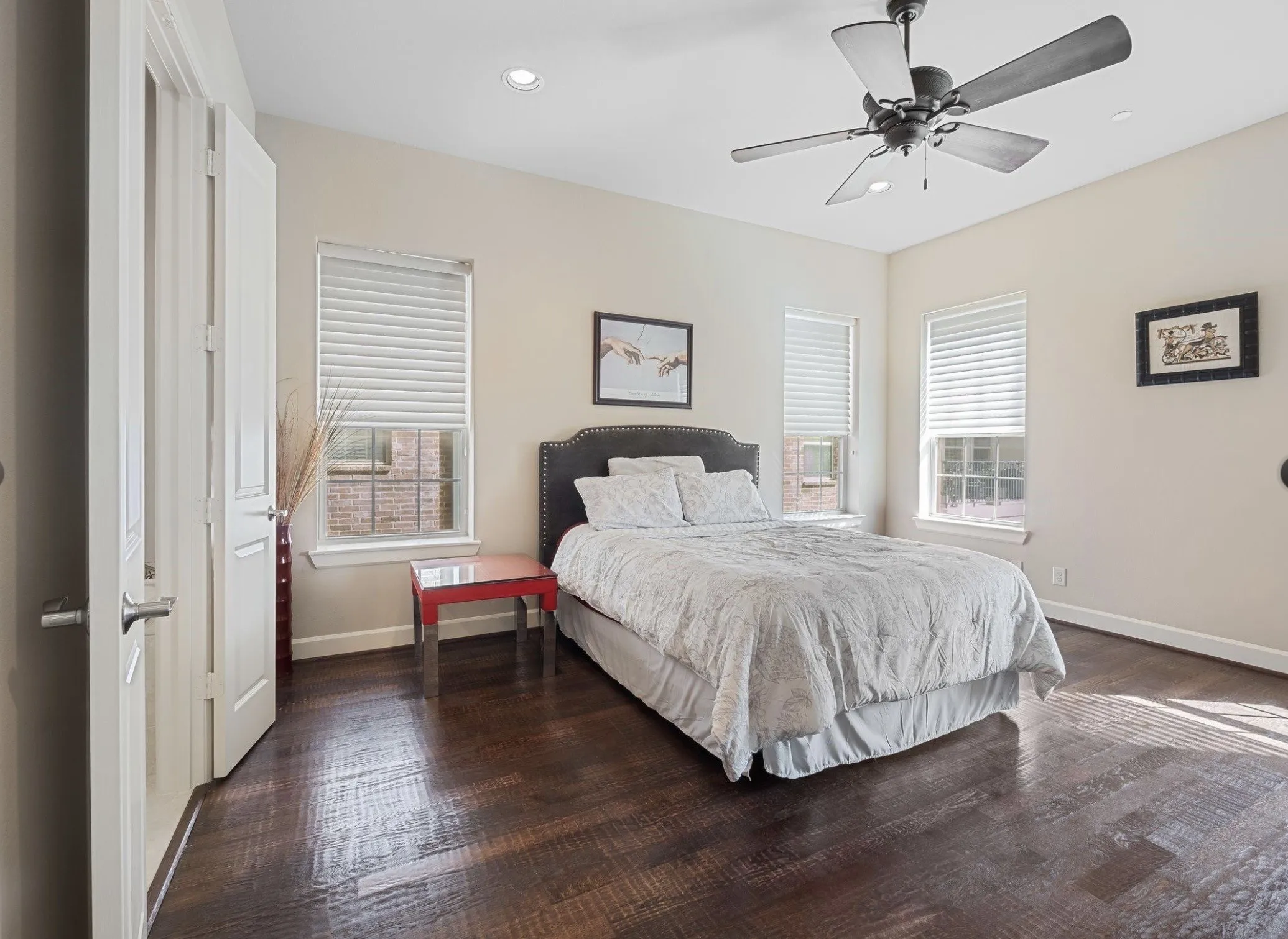 Spacious room featuring rich wood-finish flooring, recessed lighting, and a ceiling fan